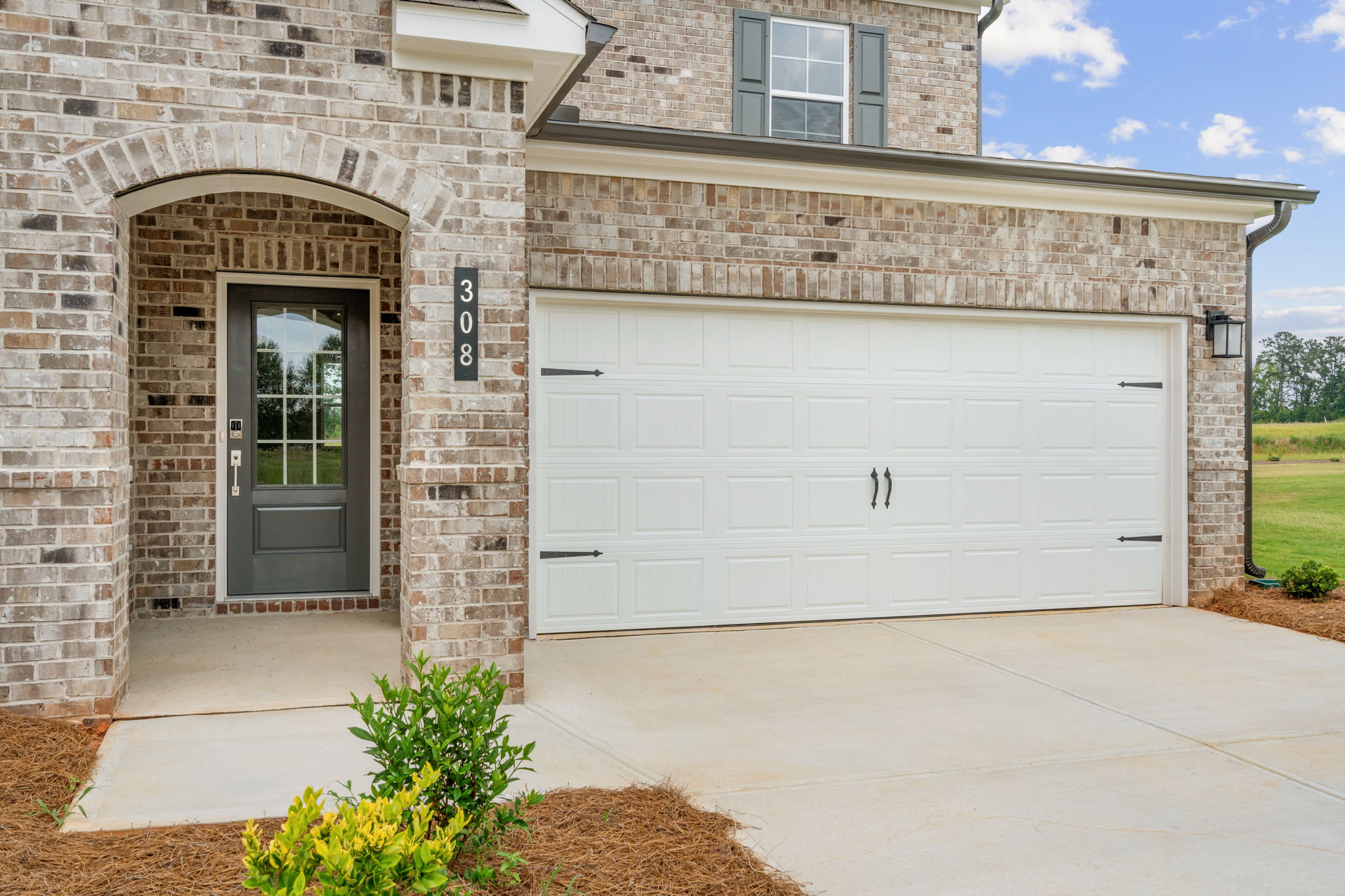 A garage door on a brick building.