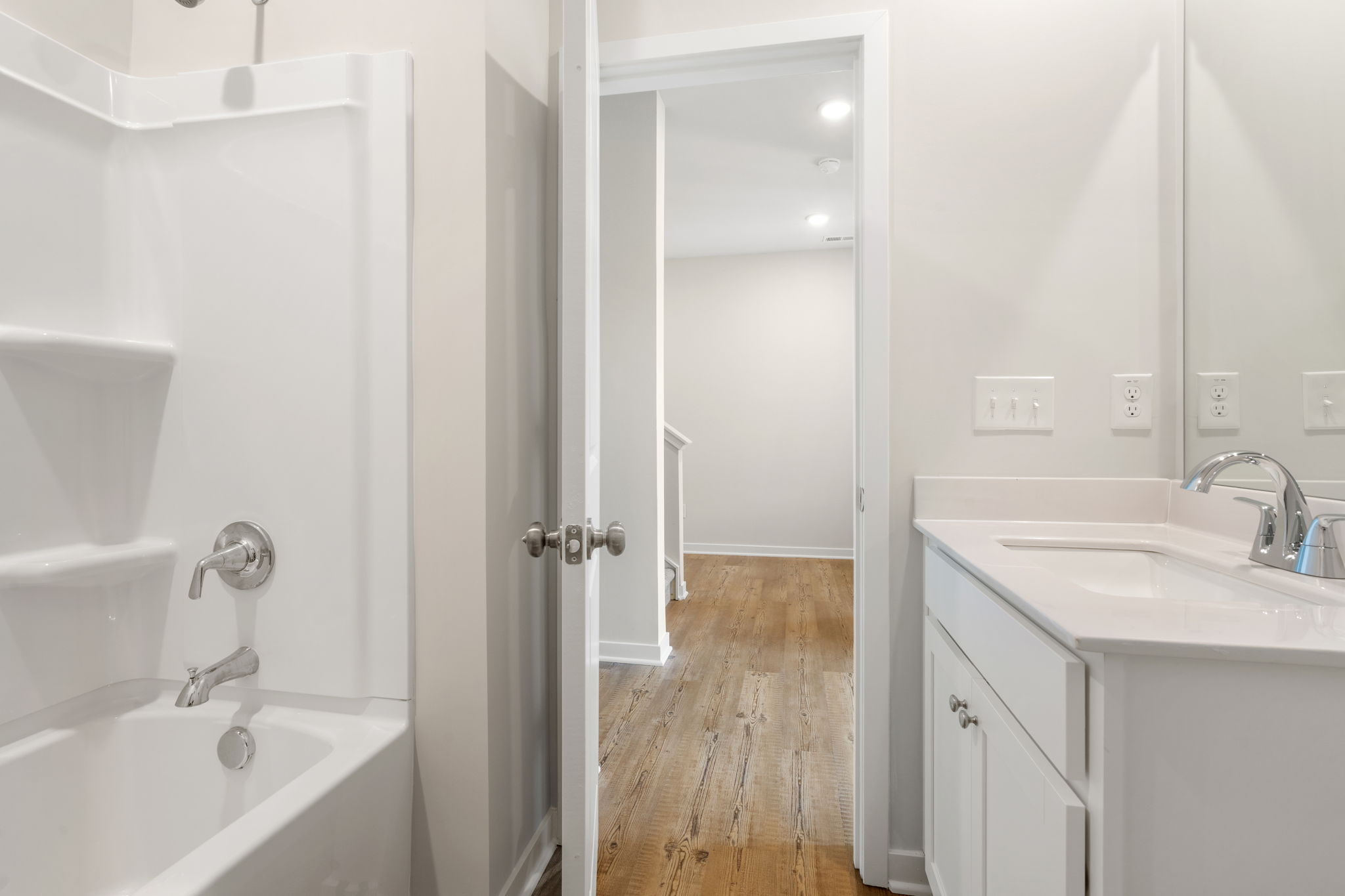 A bathroom with a tub sink and a shower.