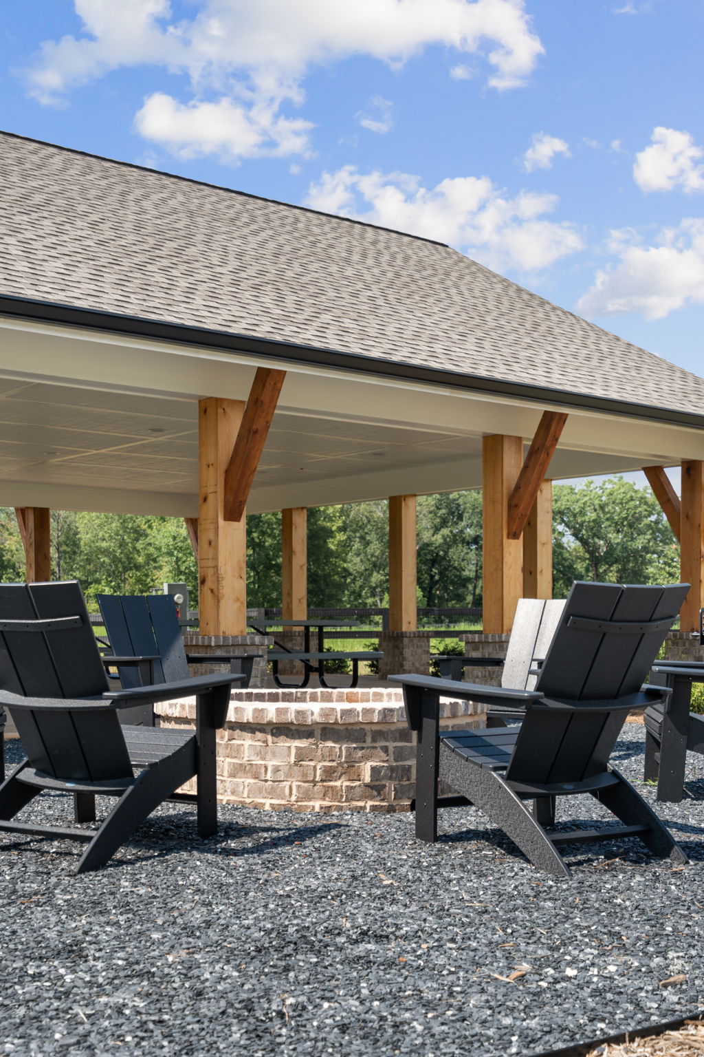 A patio with chairs and a table.