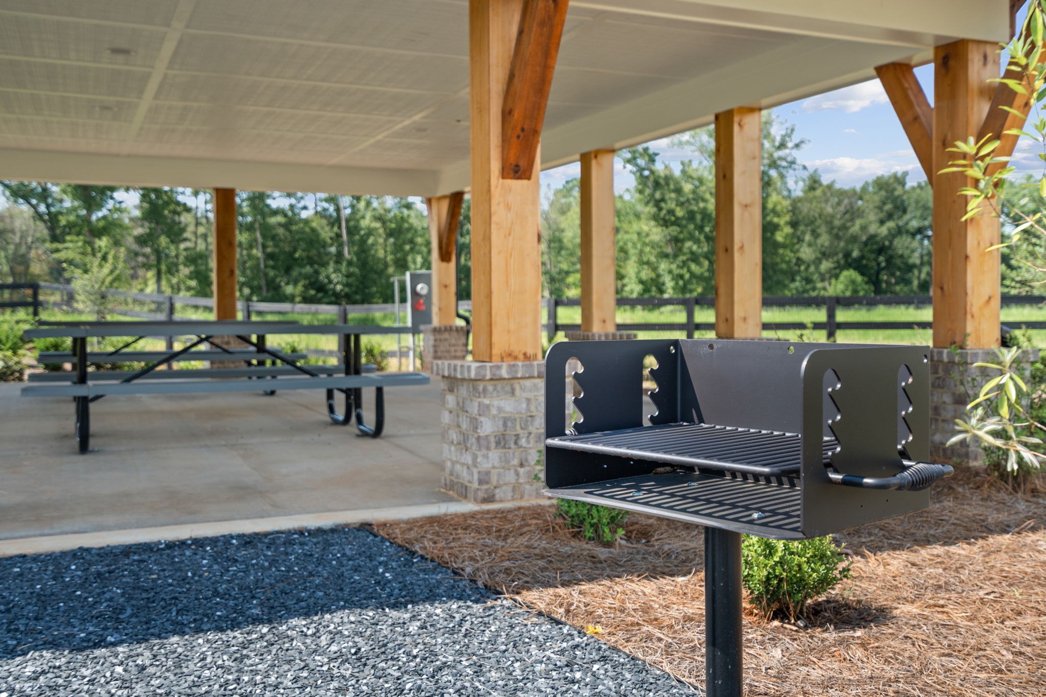 A picnic table and chairs under a covered area.