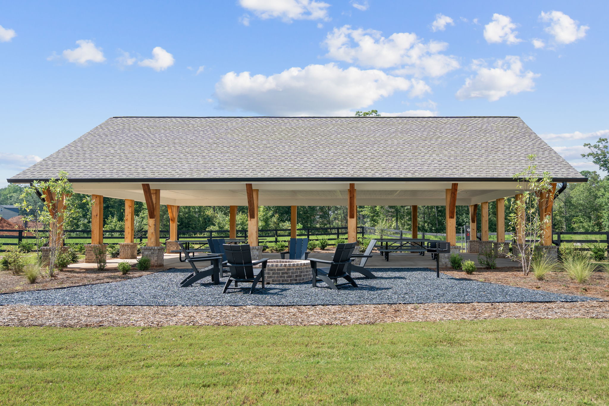 A covered patio with chairs and tables.