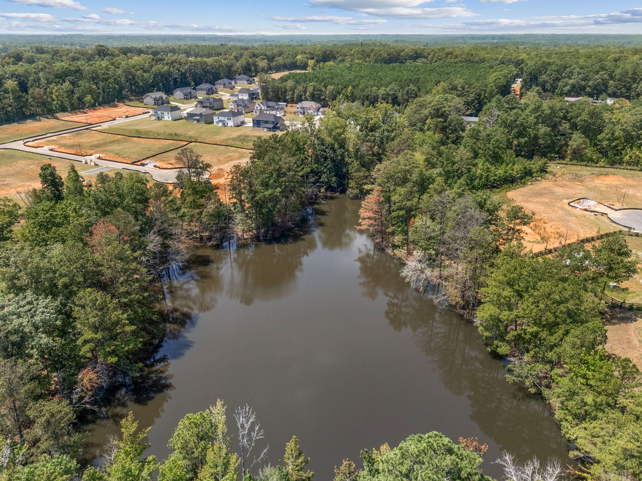 A river with a small town in the distance.