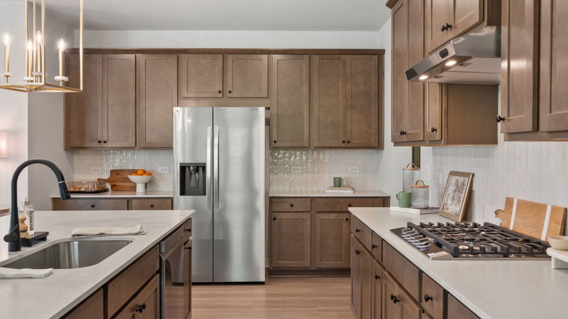 A kitchen with wooden cabinets.