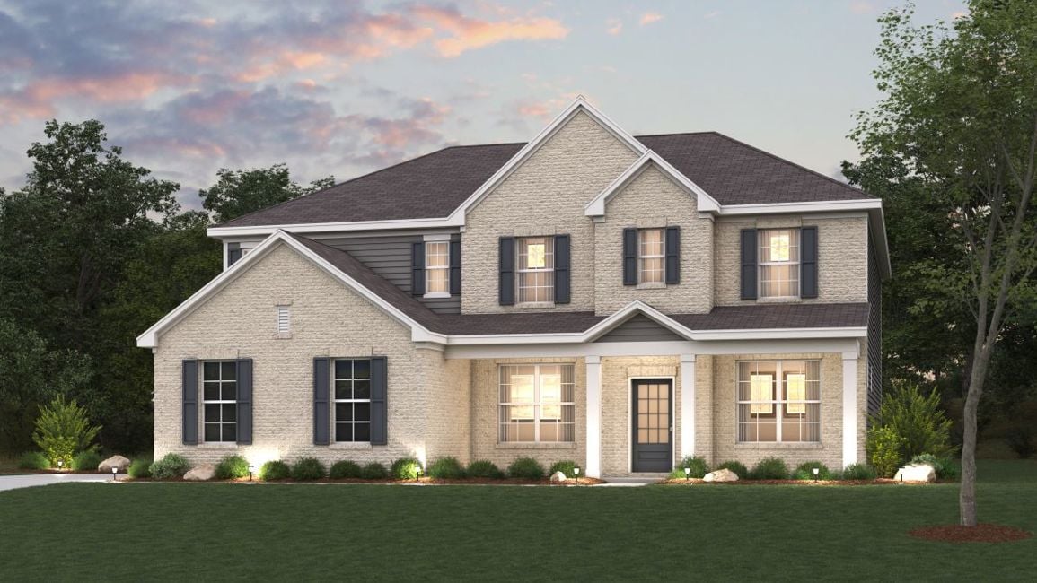 A large house with a lawn in front of it.