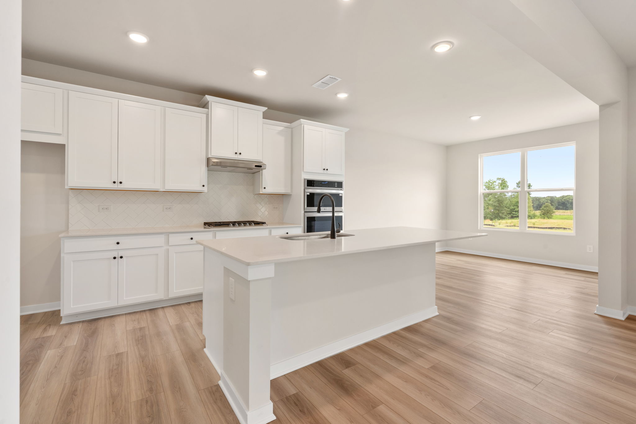A kitchen with white cabinets.