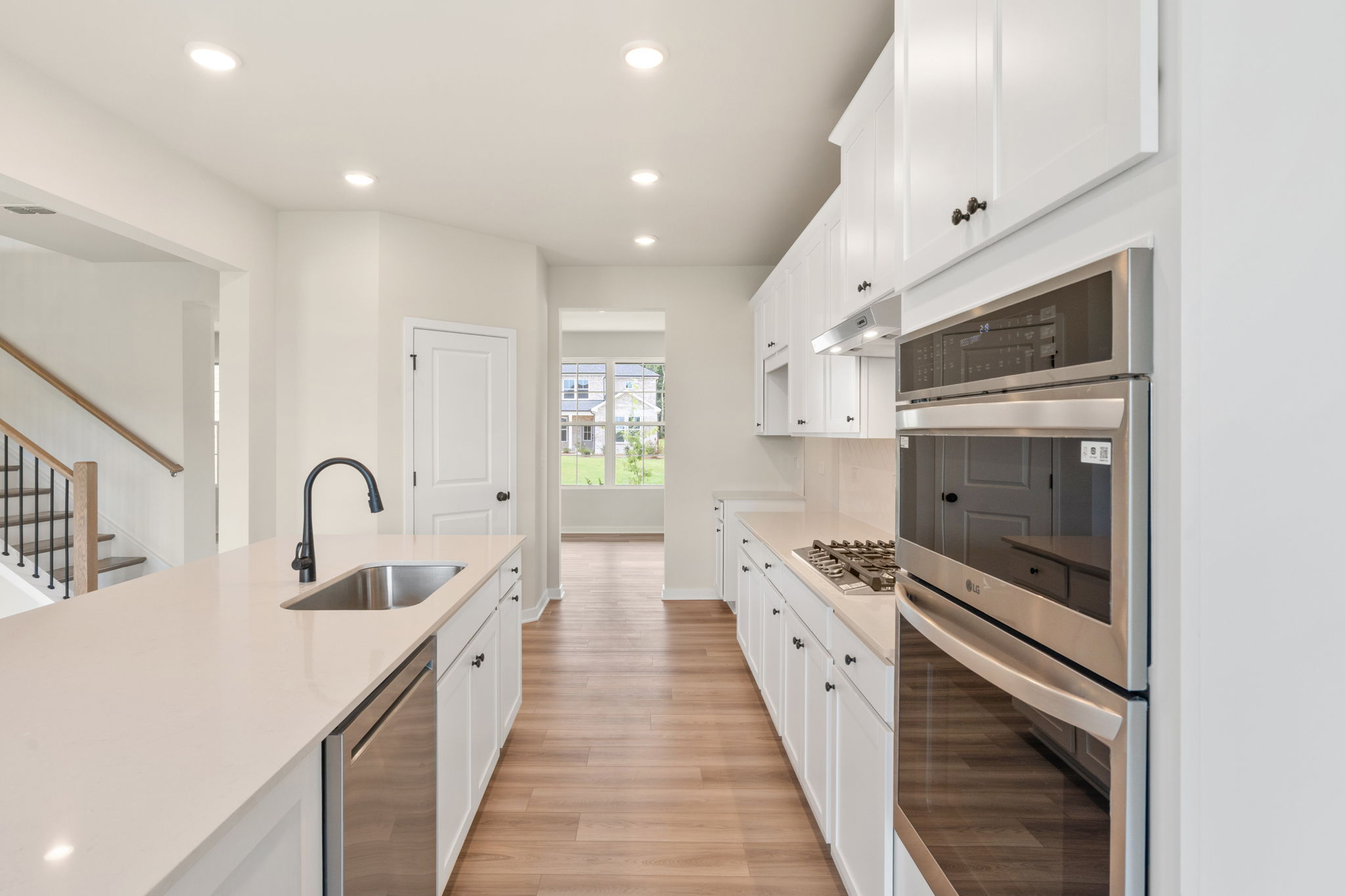 A kitchen with white cabinets.