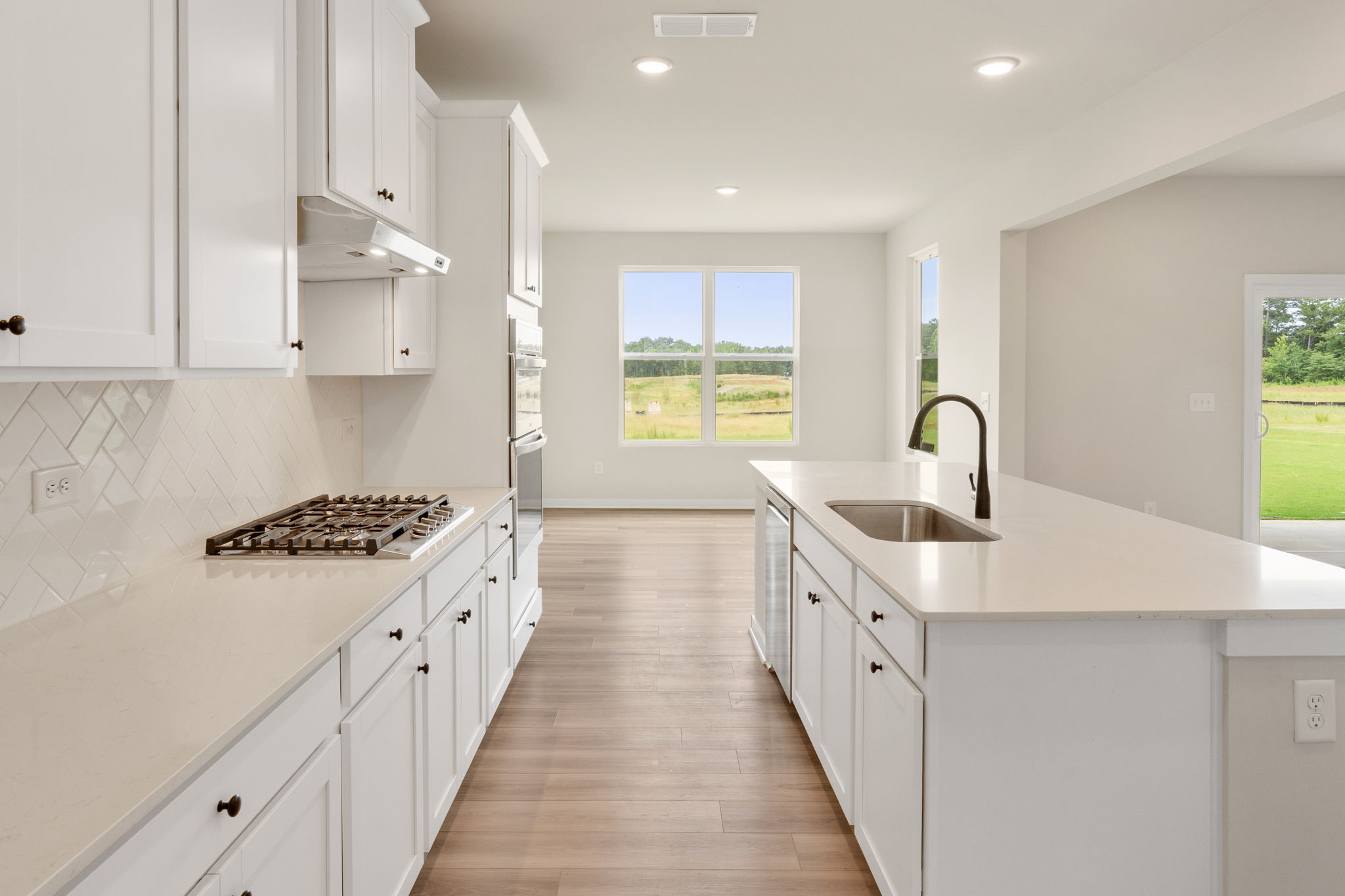 A kitchen with white cabinets.