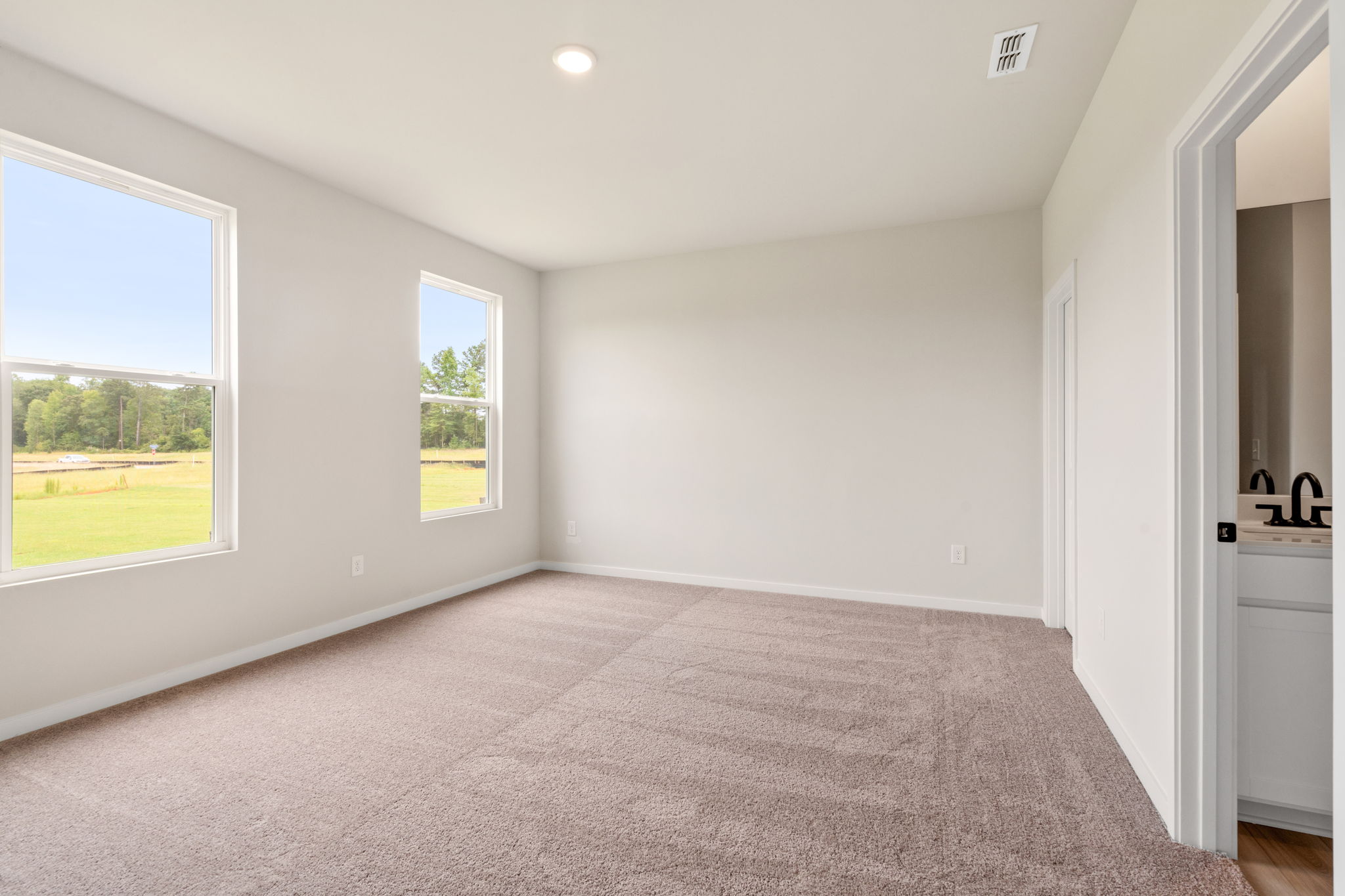 A room with a window and a carpet.