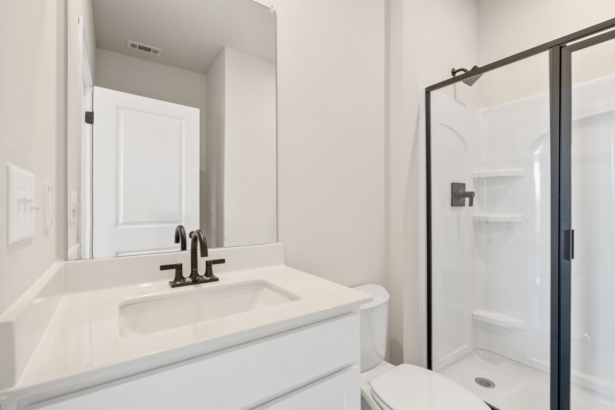 A bathroom with a glass shower.