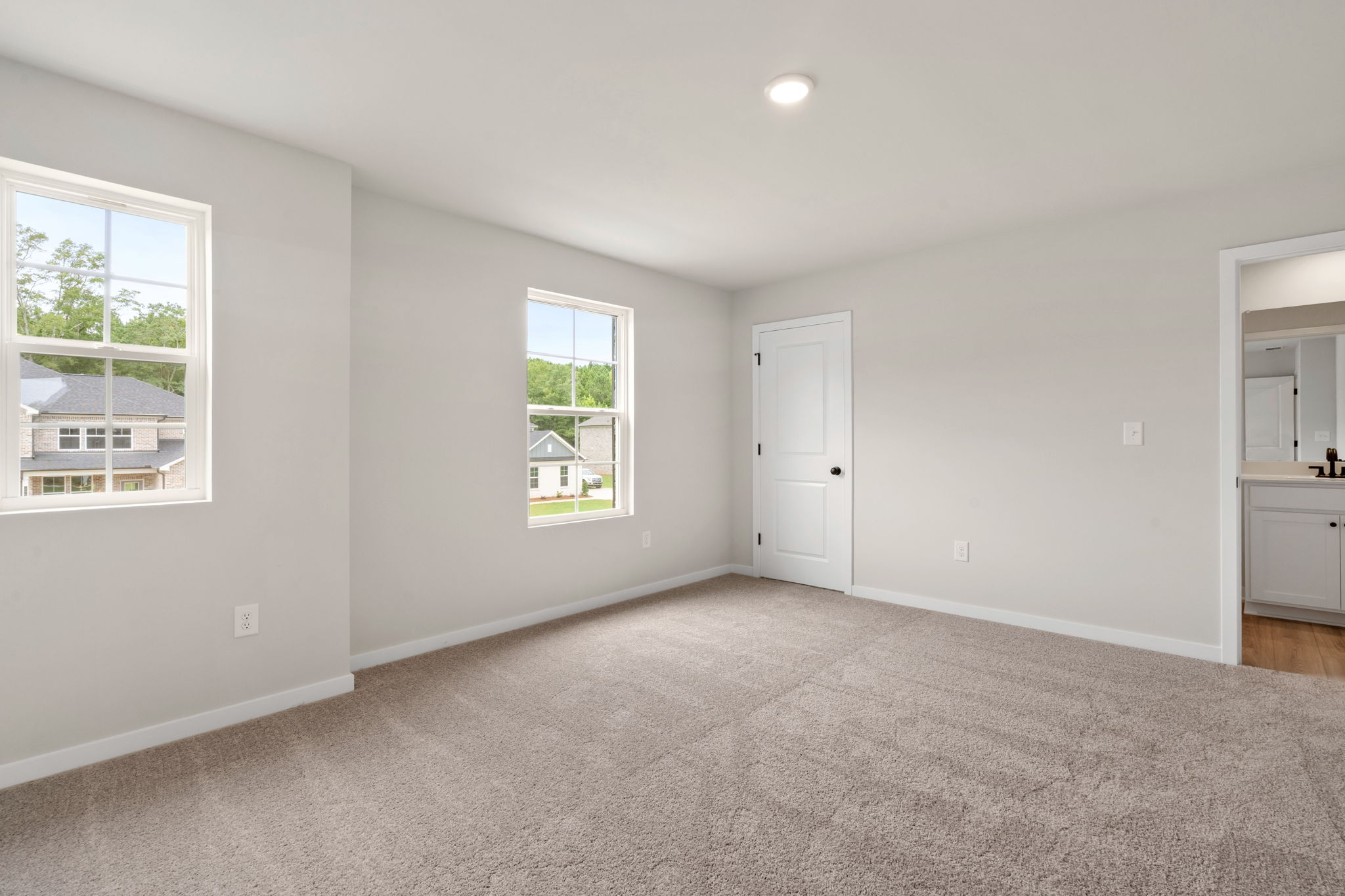 A room with a white door and windows.