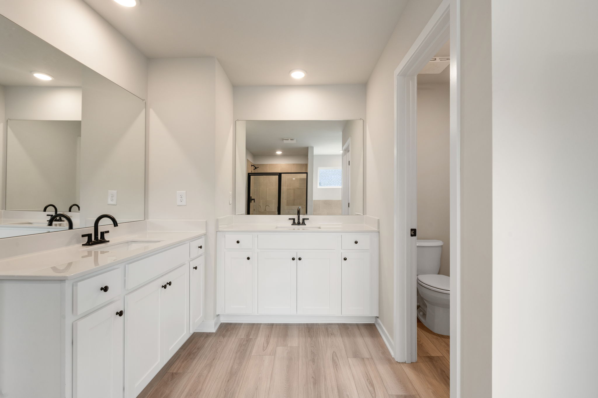 A bathroom with white cabinets.
