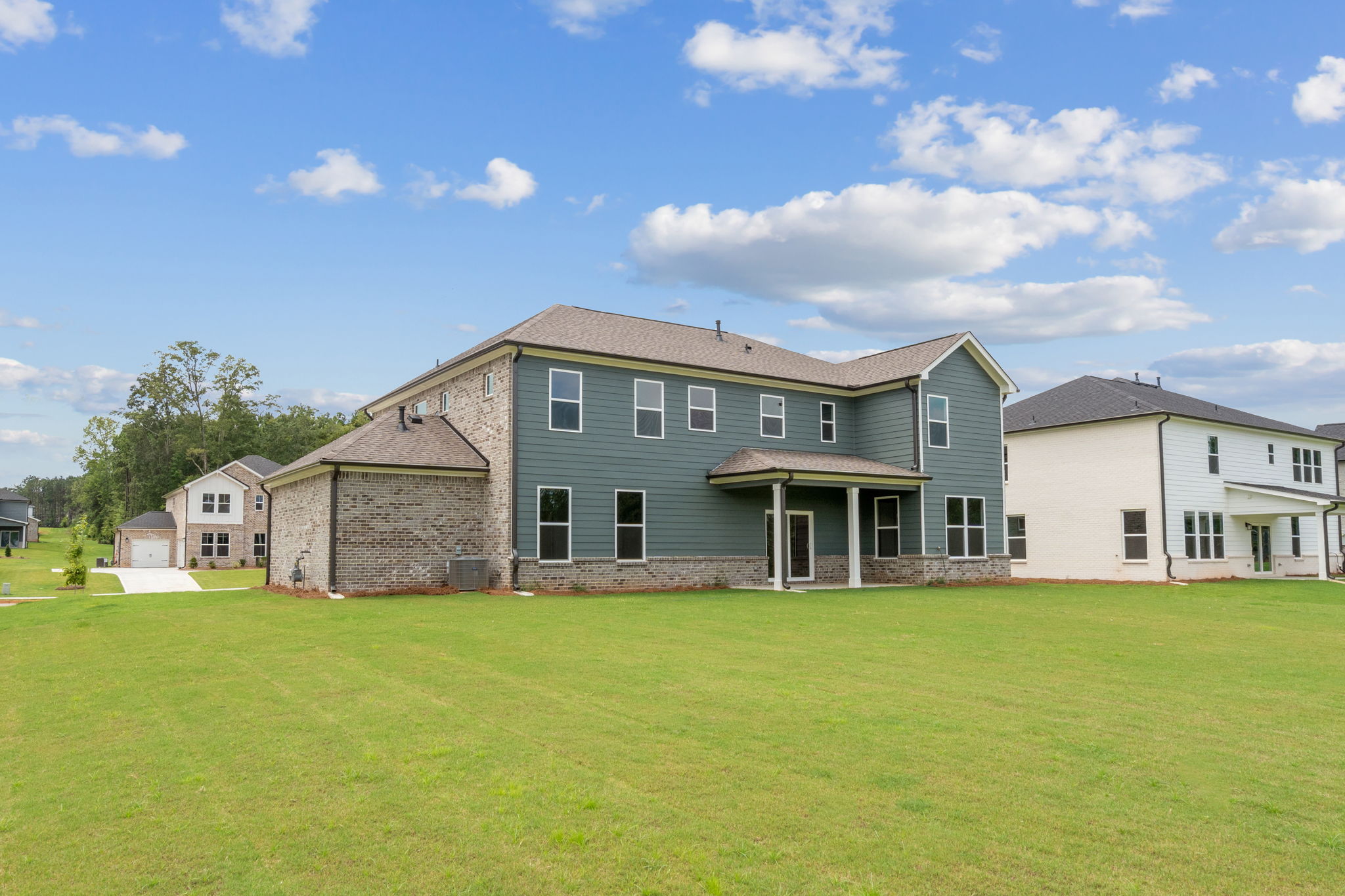 A large house with a grass yard.