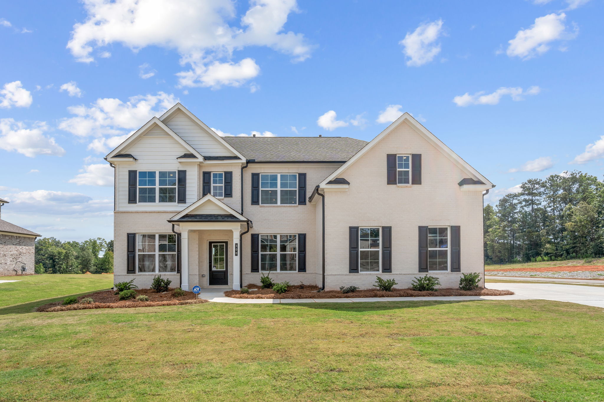 A large house with a lawn in front of it.