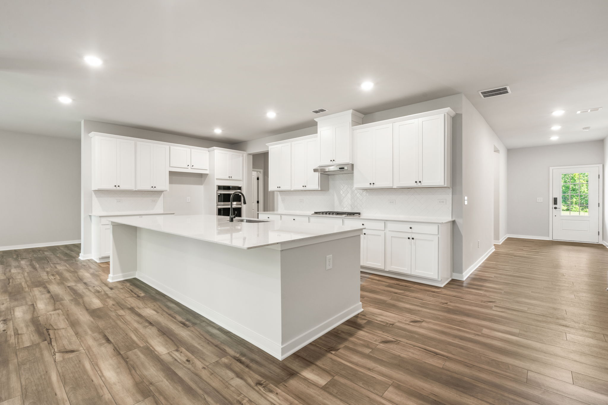 A kitchen with white cabinets.