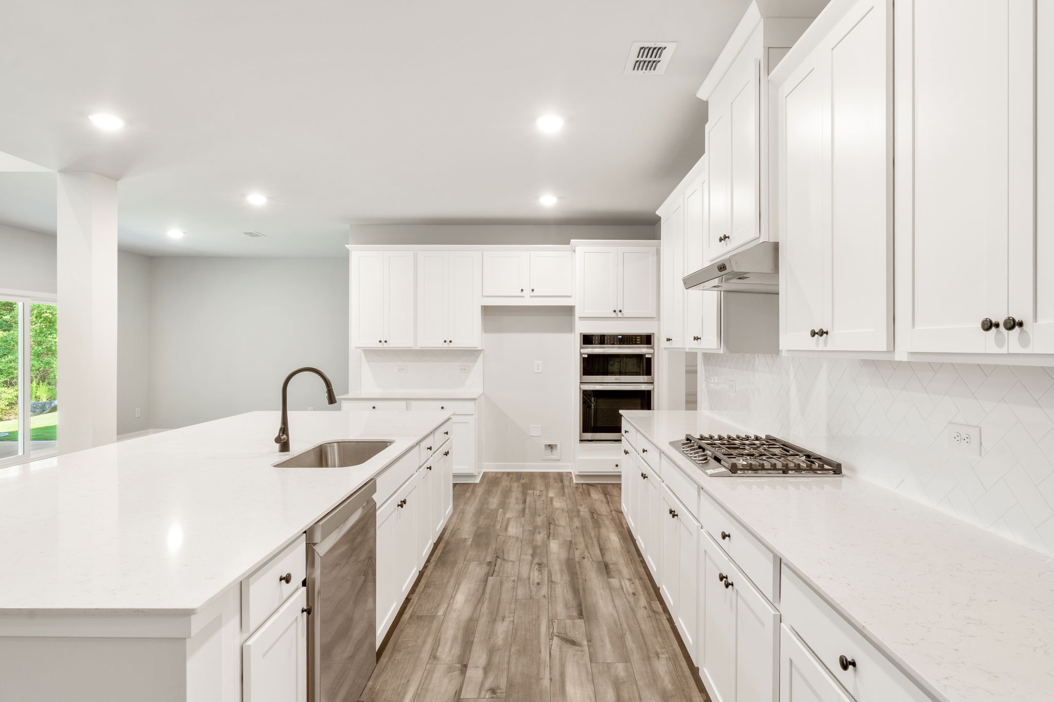 A kitchen with white cabinets.