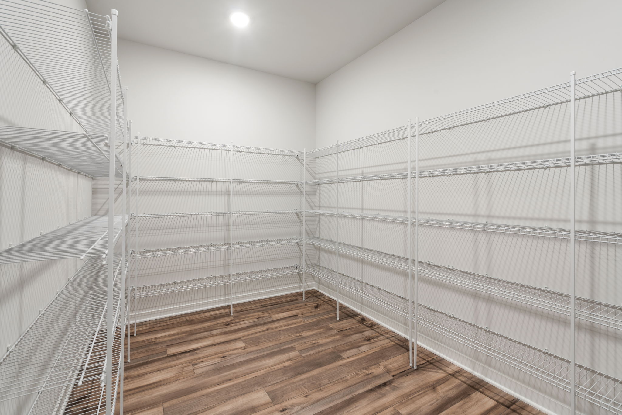 A white room with a wood floor.
