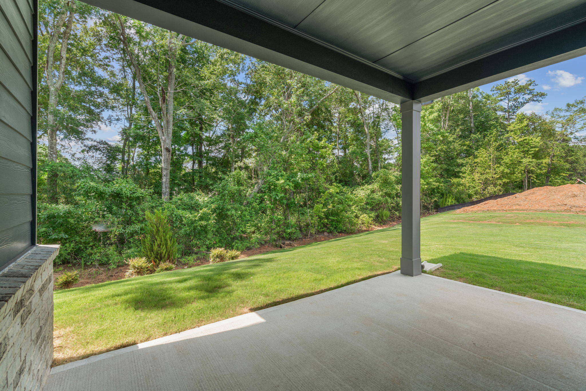 A view of a yard through a window of a house.