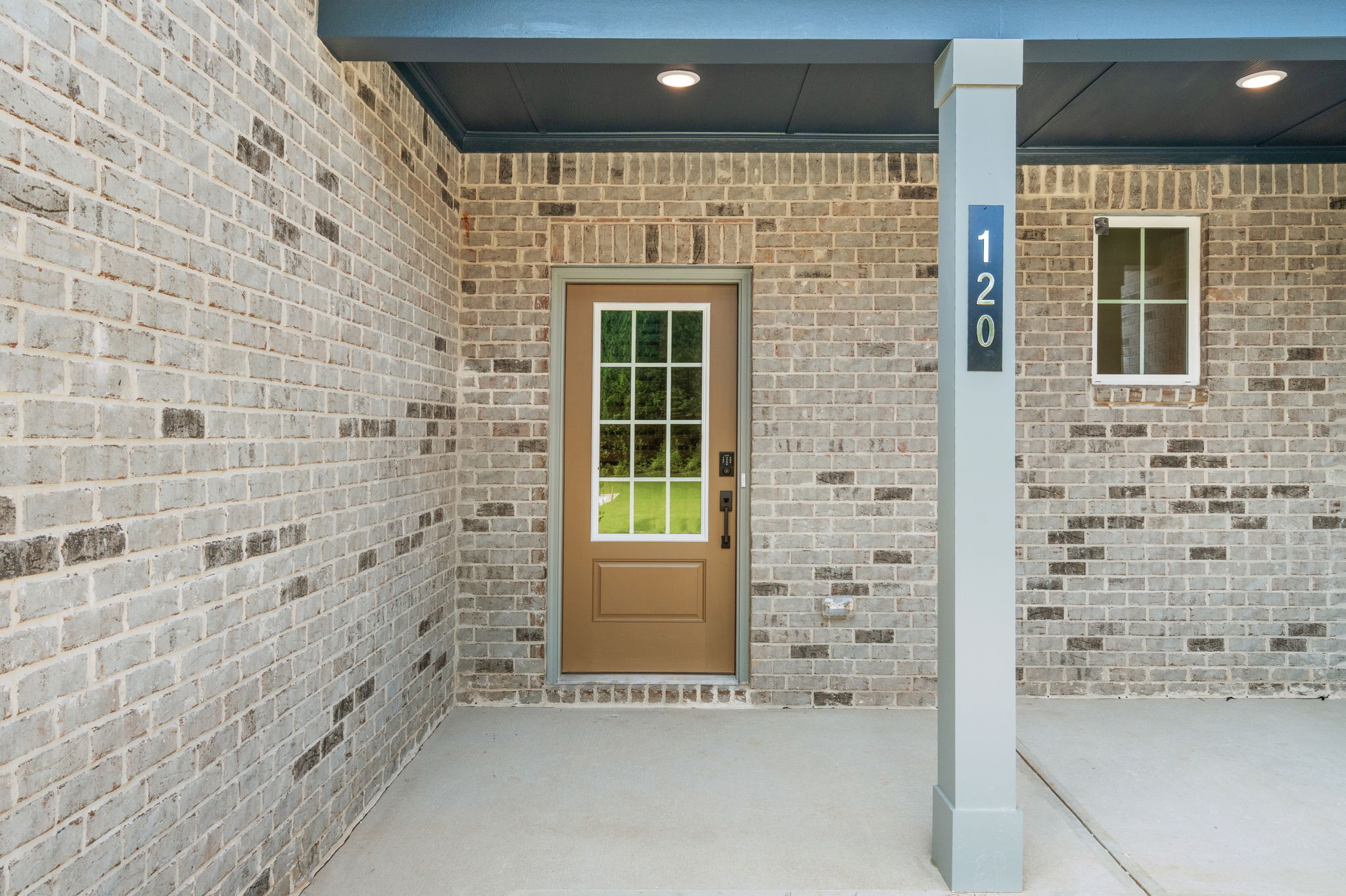 A brick building with a white pillar.