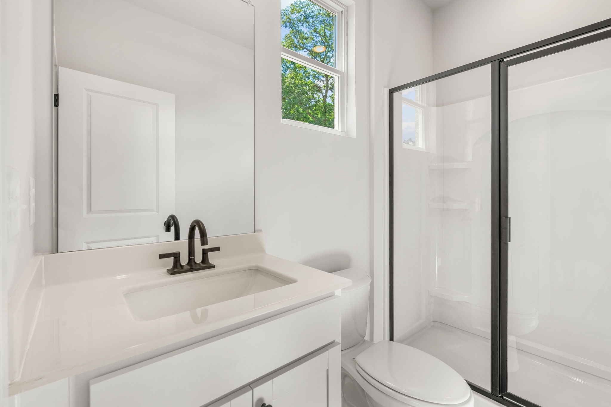 A bathroom with a sink and shower.