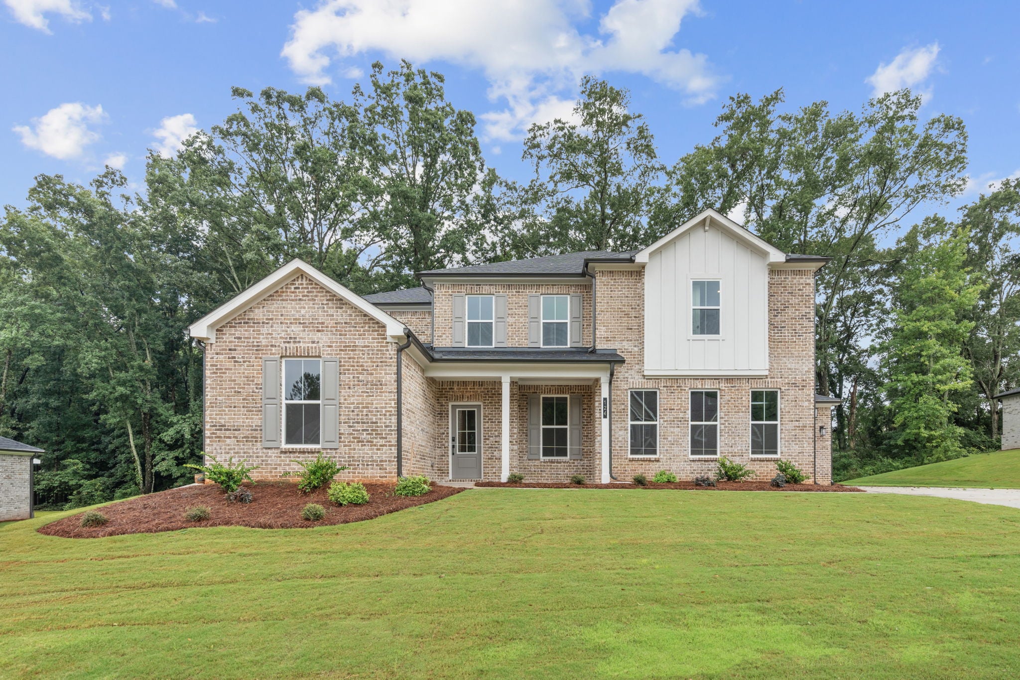 A large house with a lawn in front of it.