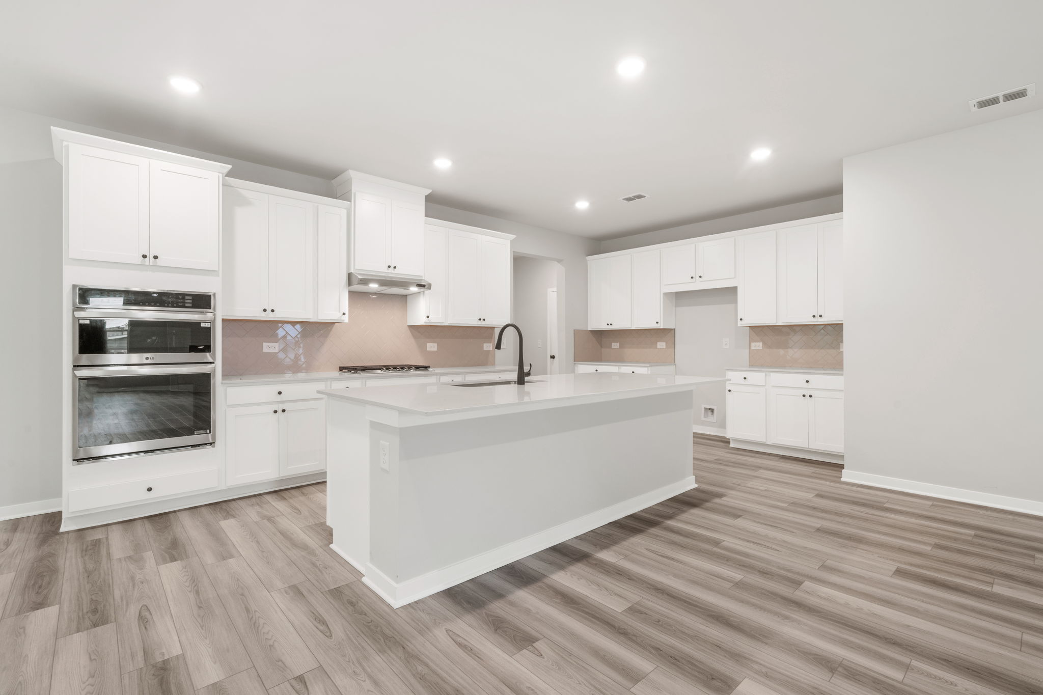 A kitchen with white cabinets.