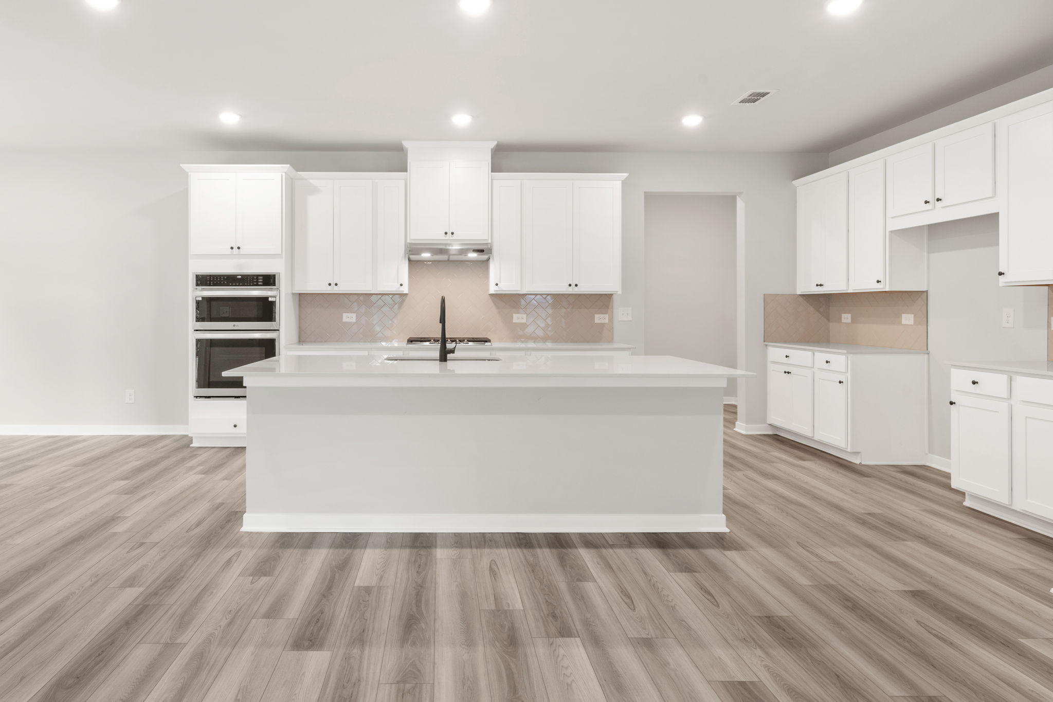 A kitchen with white cabinets.