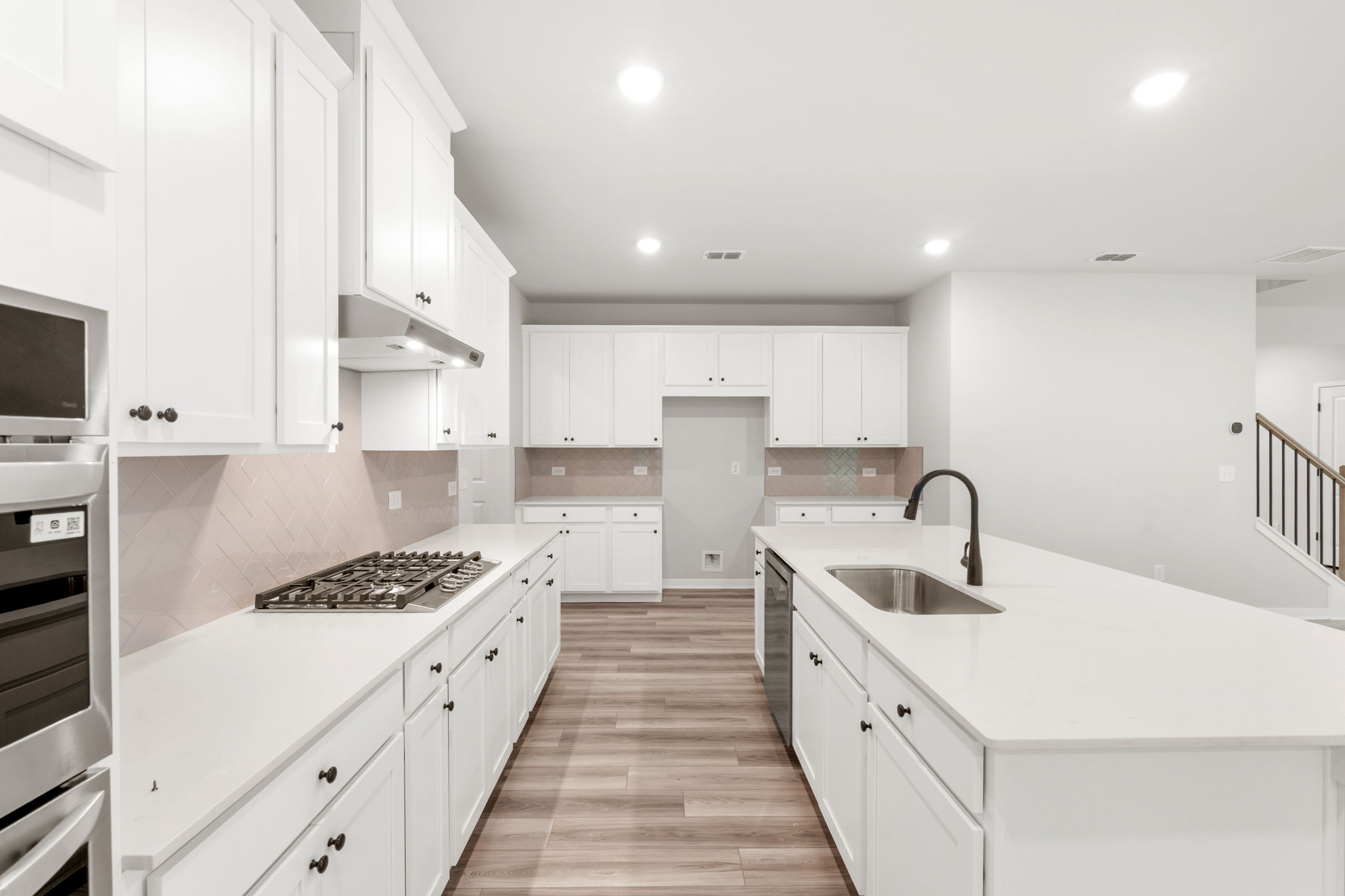 A kitchen with white cabinets.