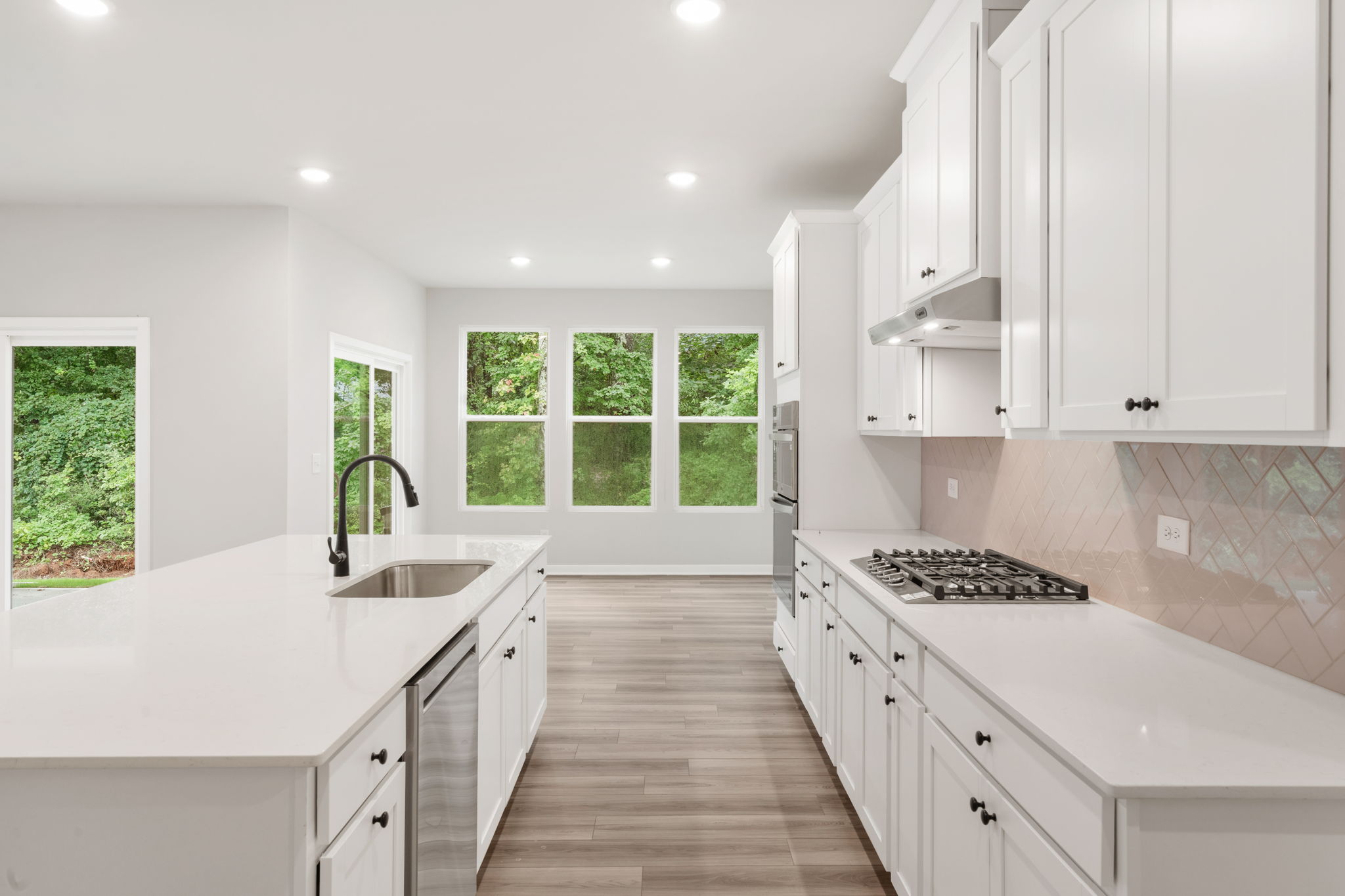 A kitchen with white cabinets.