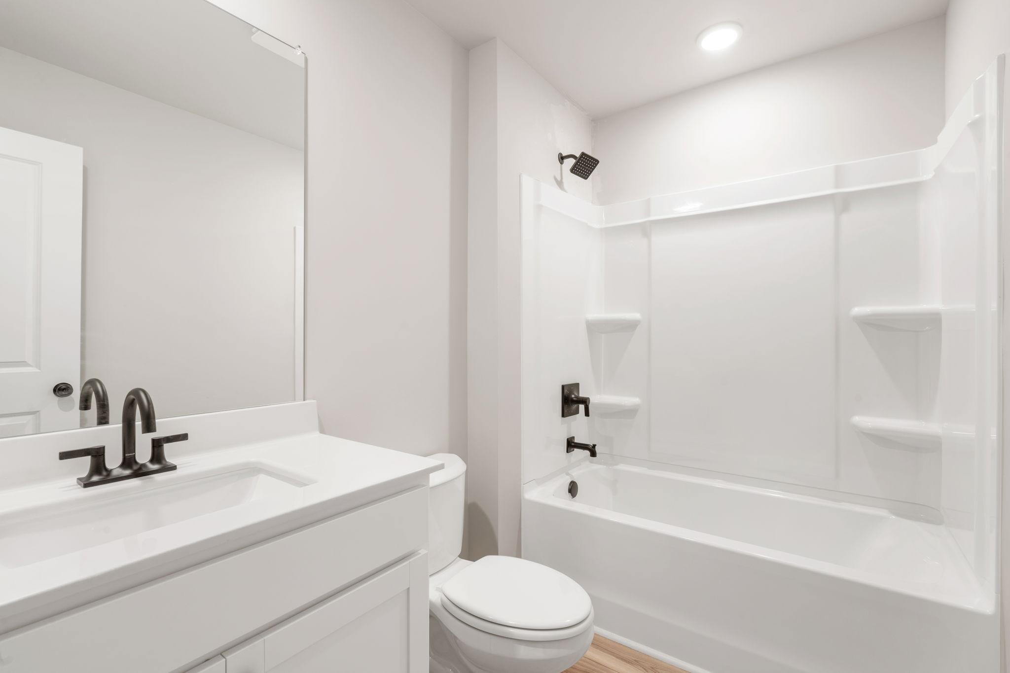 A bathroom with a tub sink and toilet.