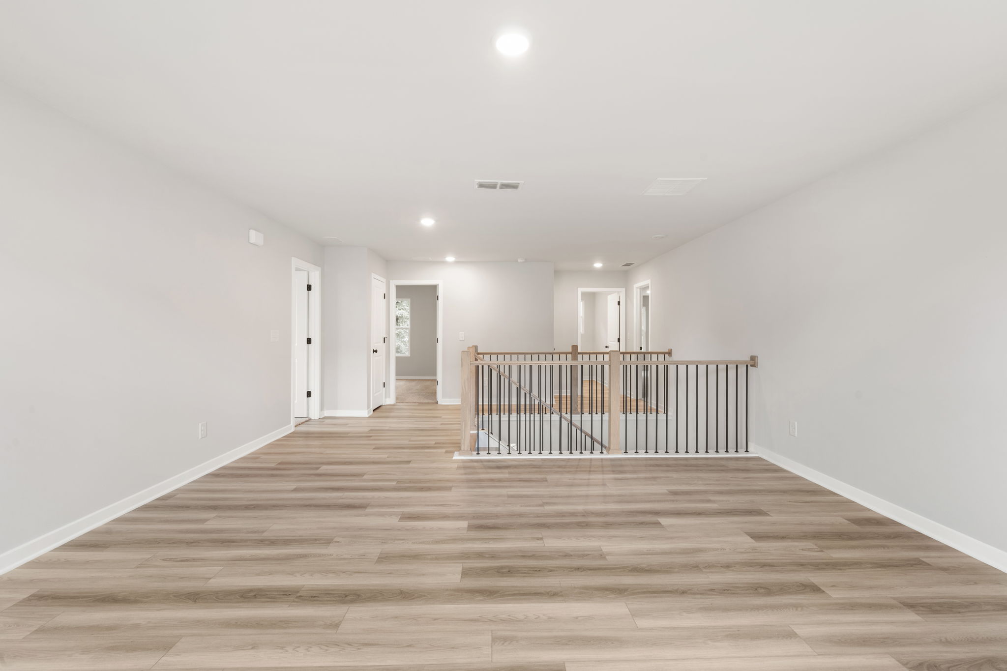 A long hallway with white walls.