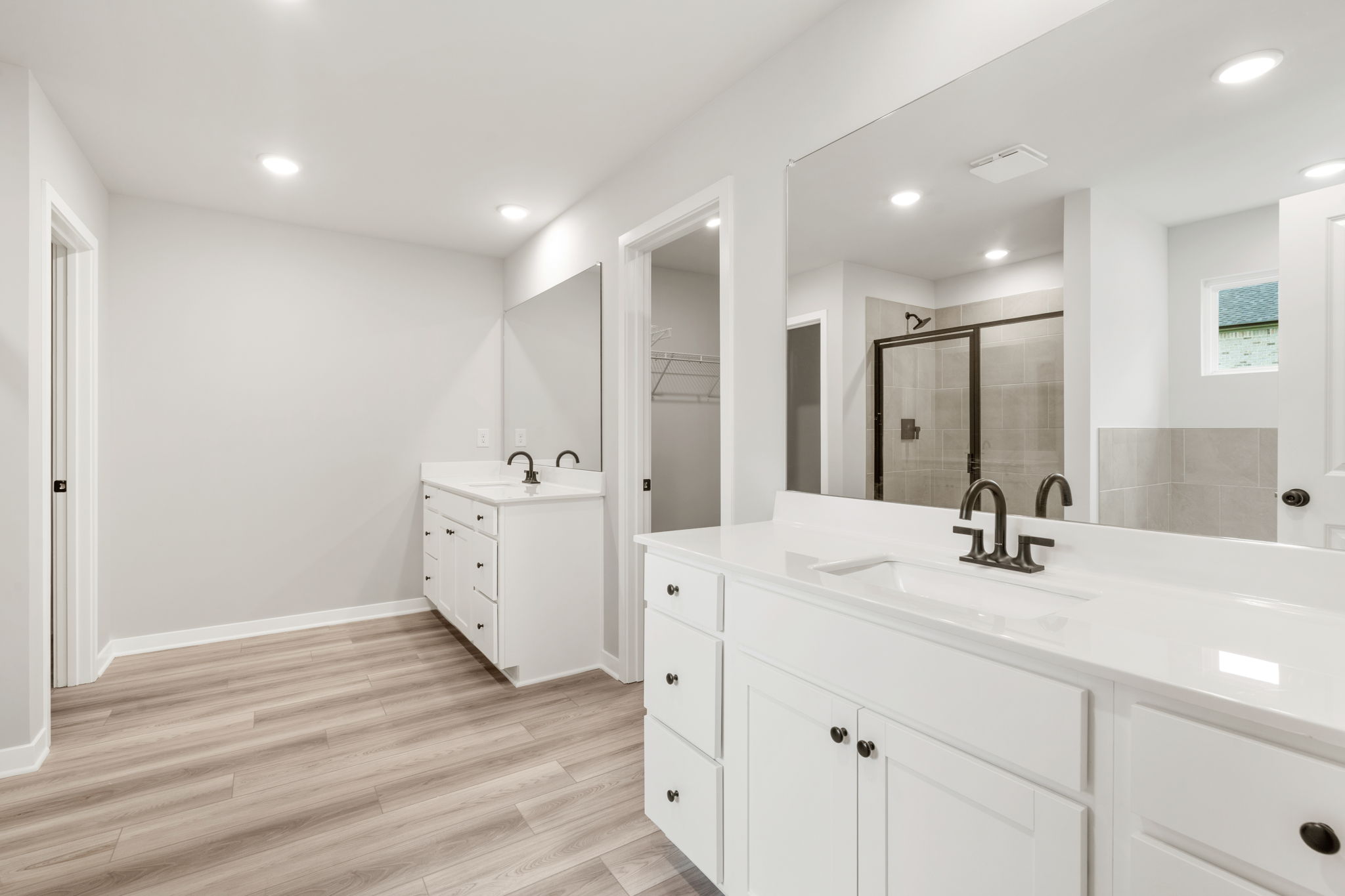 A bathroom with white cabinets.