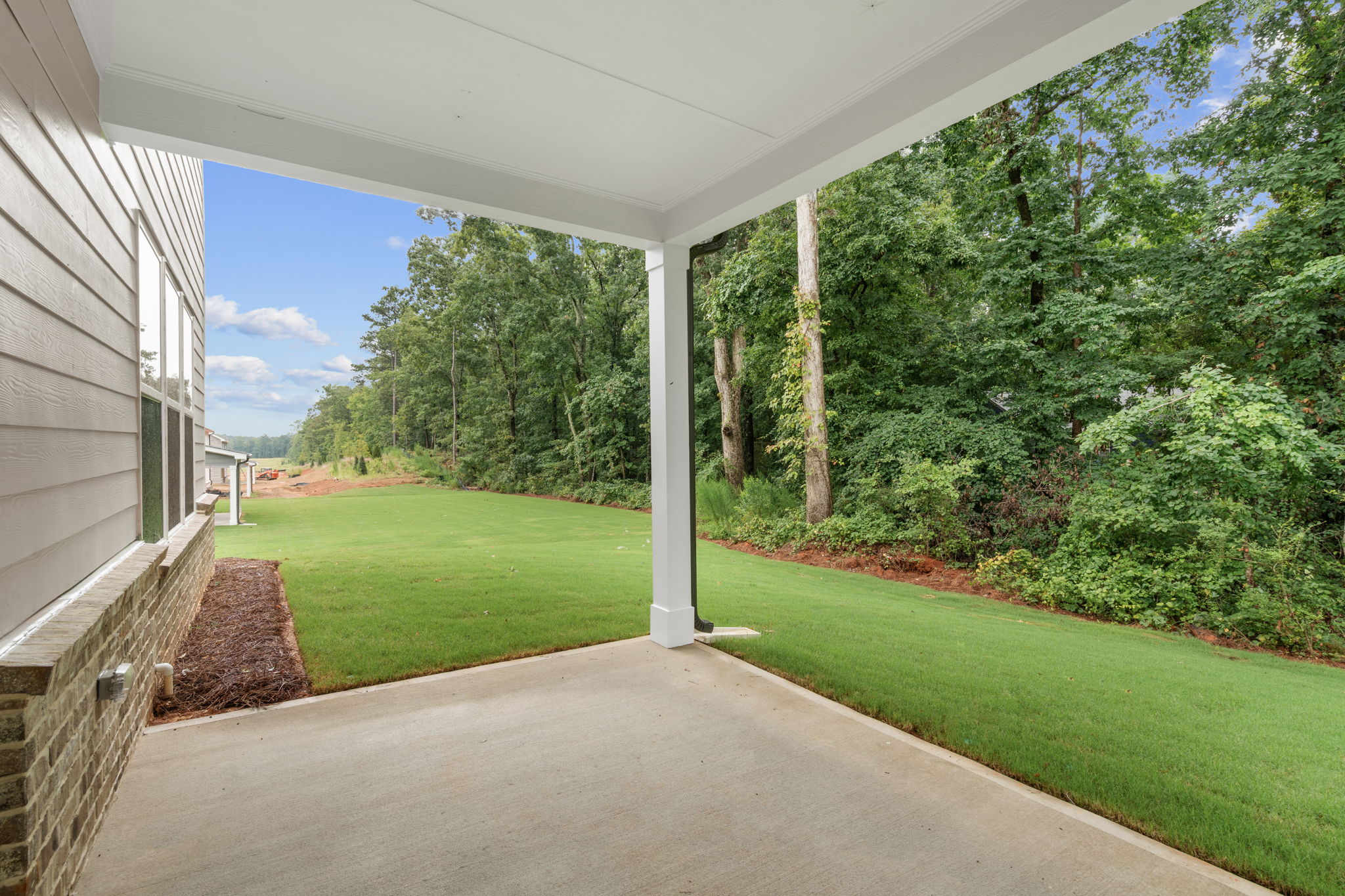 A walkway with grass and trees.
