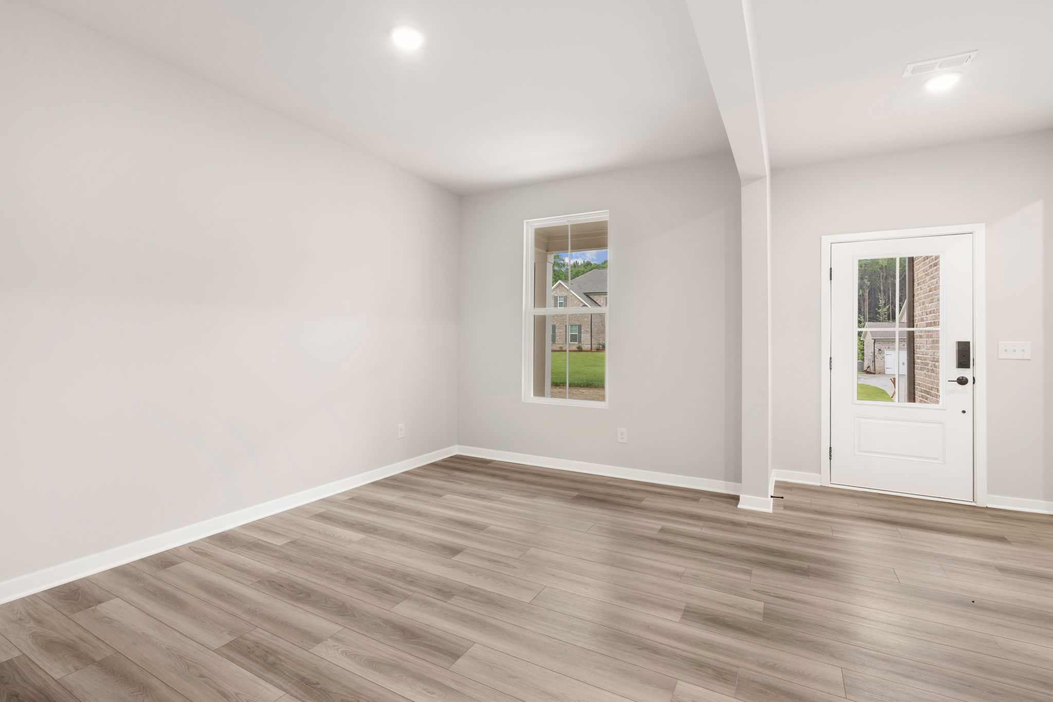 A room with a wood floor and a white door.