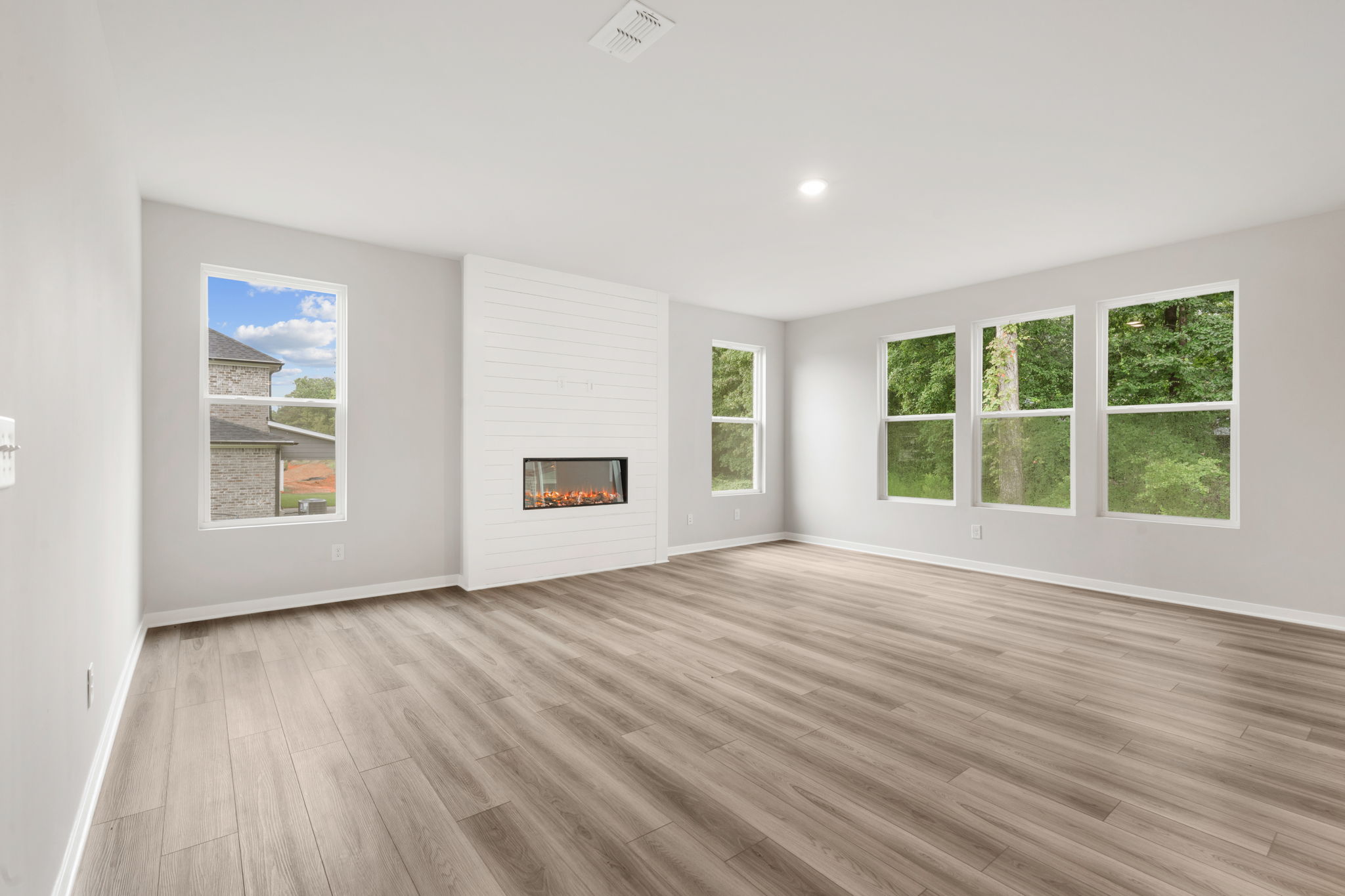 A room with a wood floor and a painting on the wall.