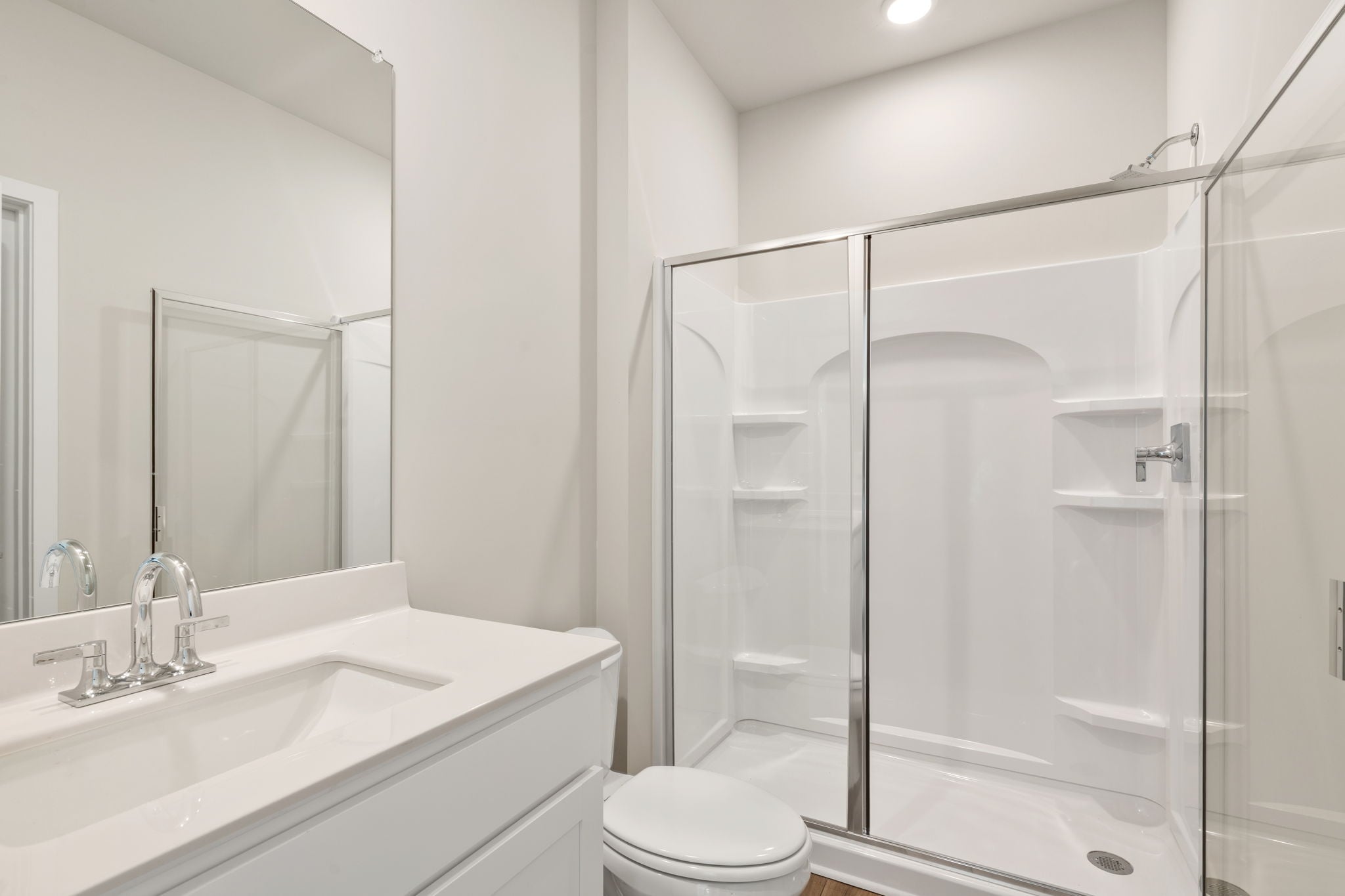 A bathroom with a glass shower.