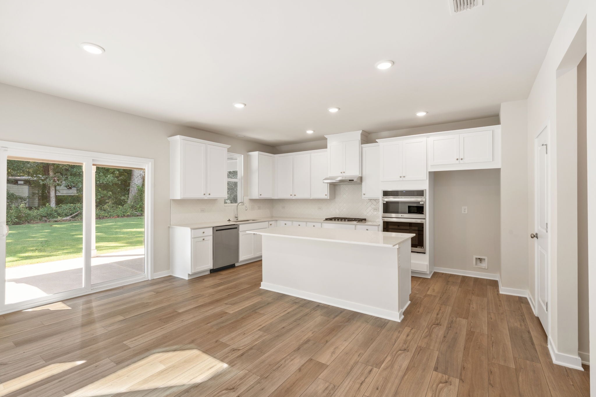 A kitchen with white cabinets.