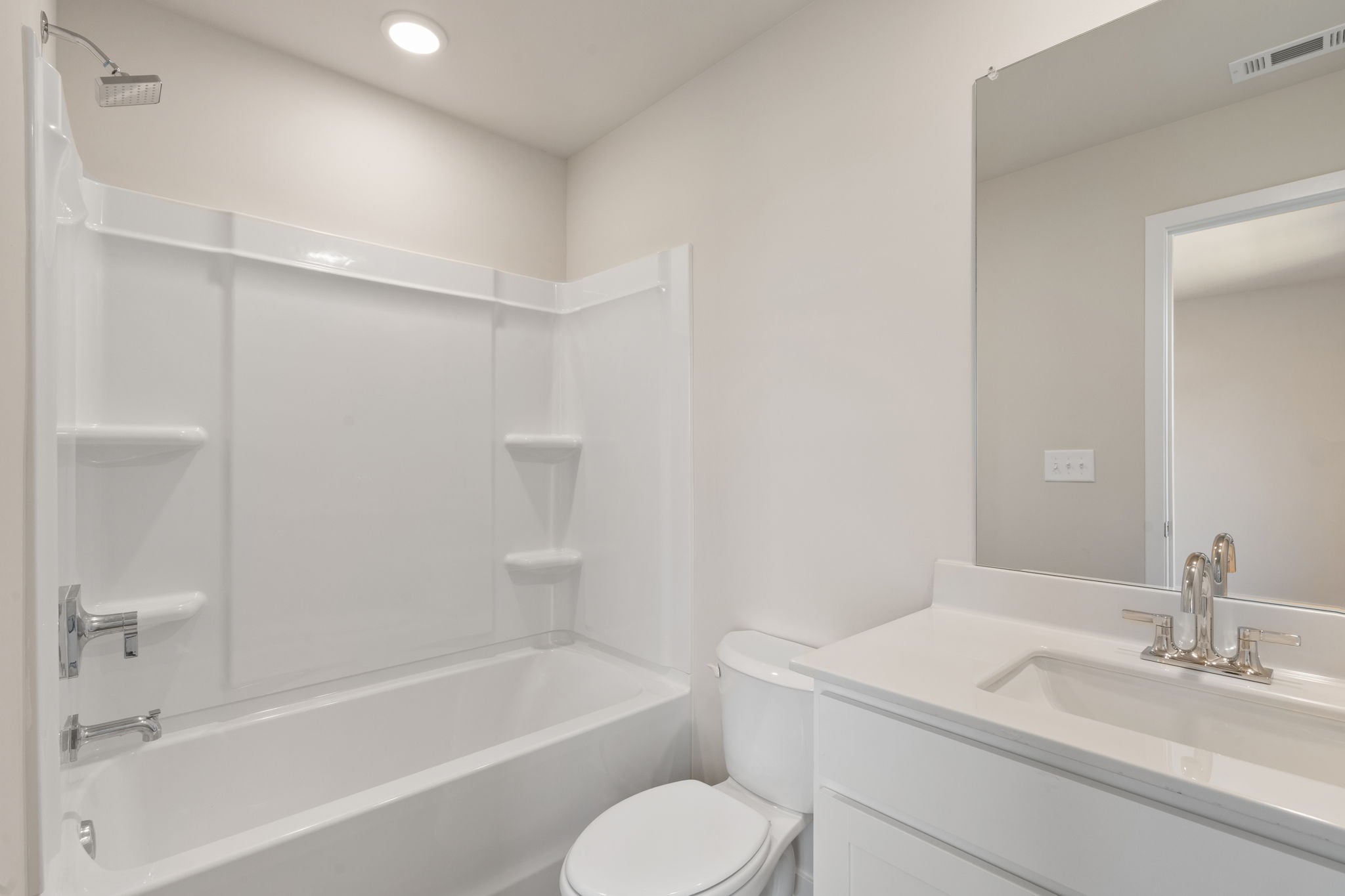 A bathroom with a tub toilet and sink.