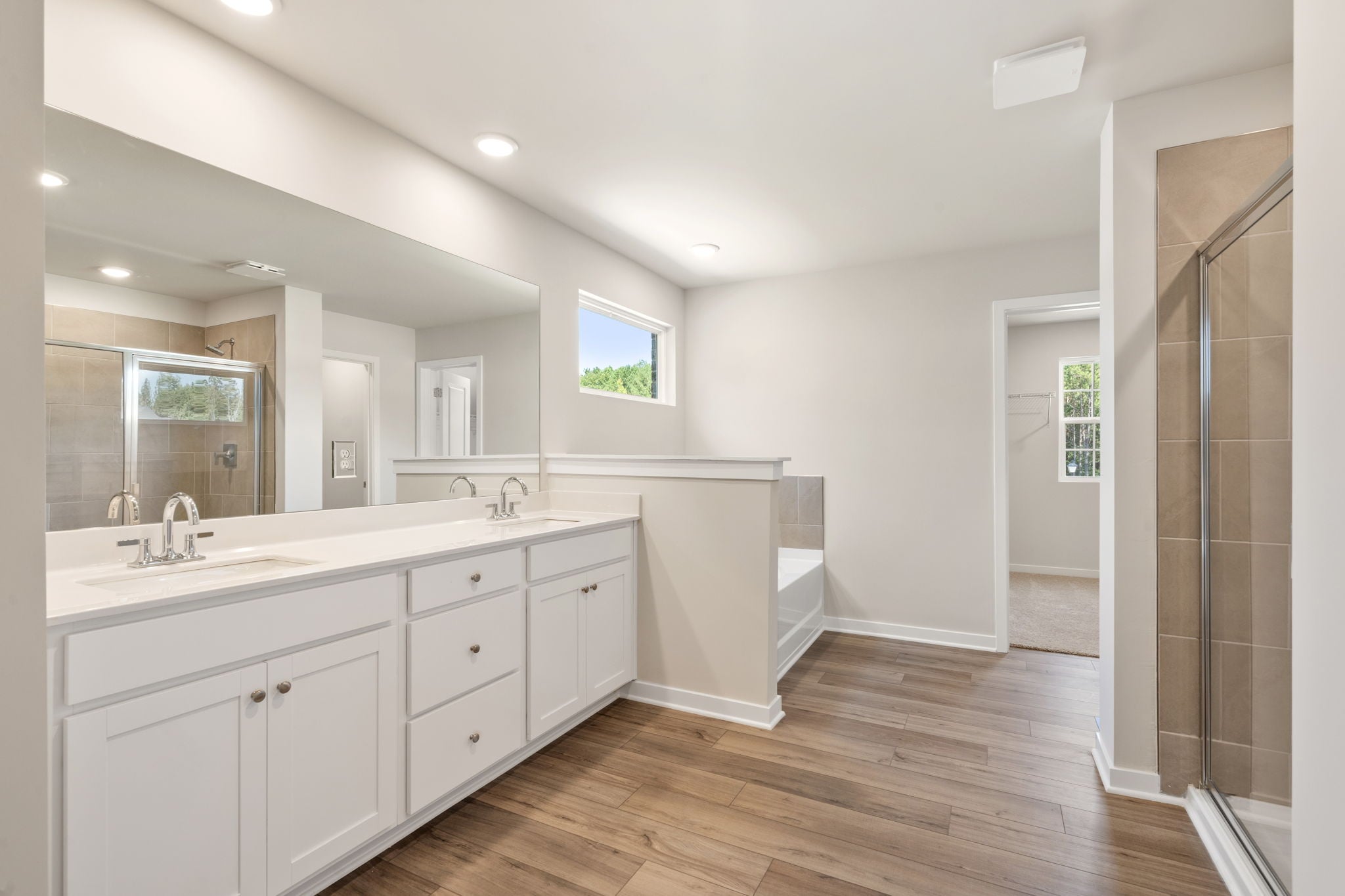 A bathroom with white cabinets.