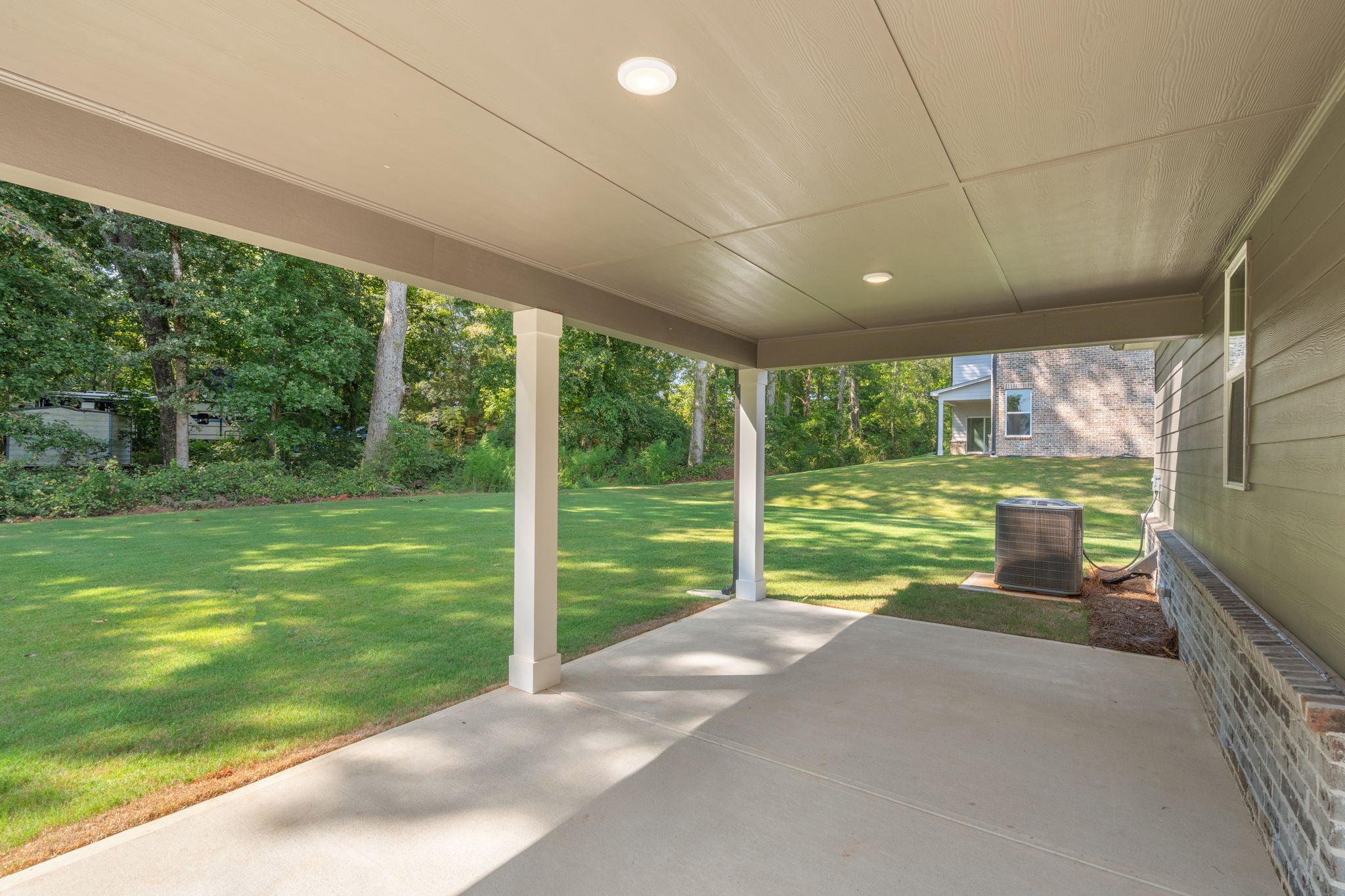 A walkway with grass and trees.