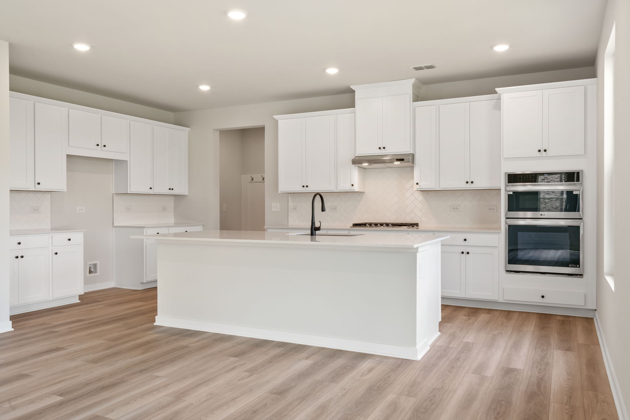 A kitchen with white cabinets.