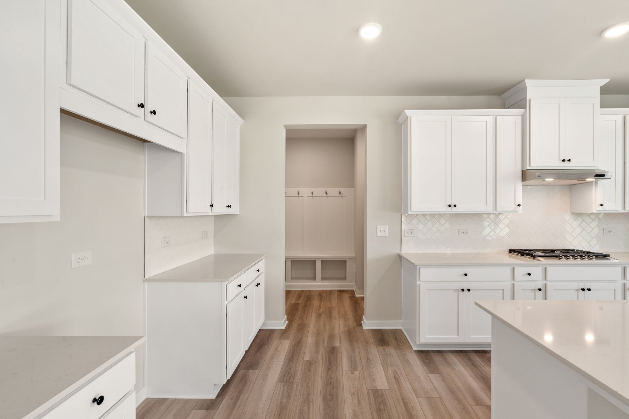 A kitchen with white cabinets.