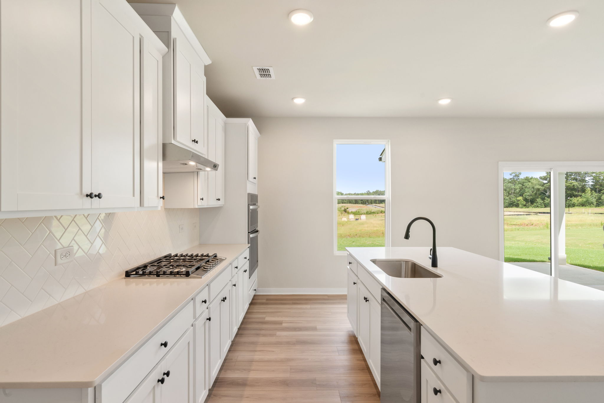 A kitchen with white cabinets.