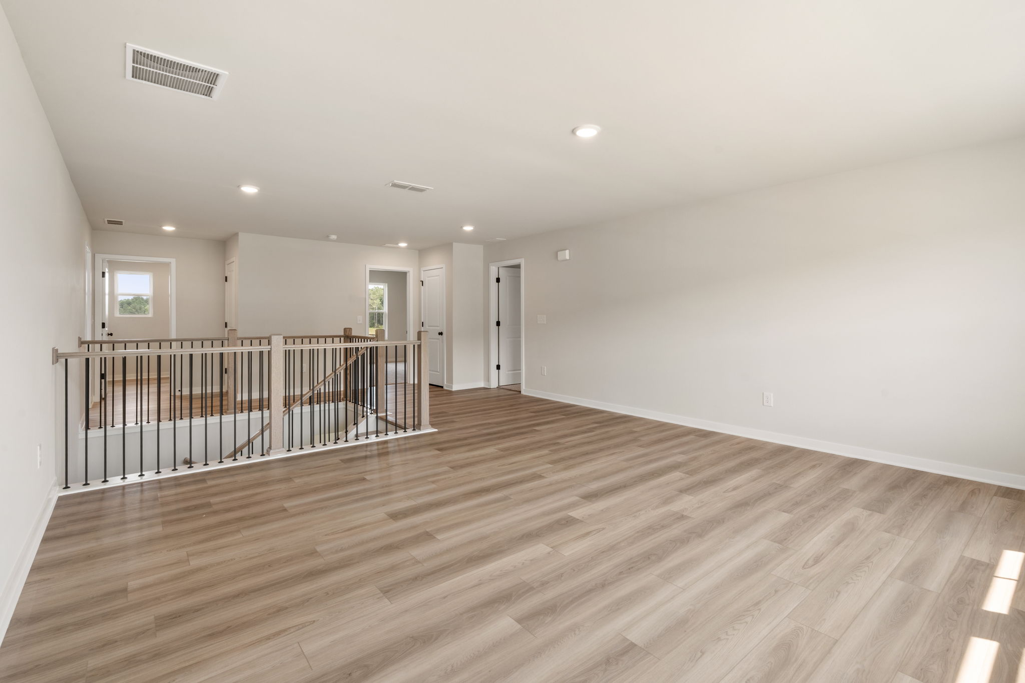 A room with a wood floor and white walls.