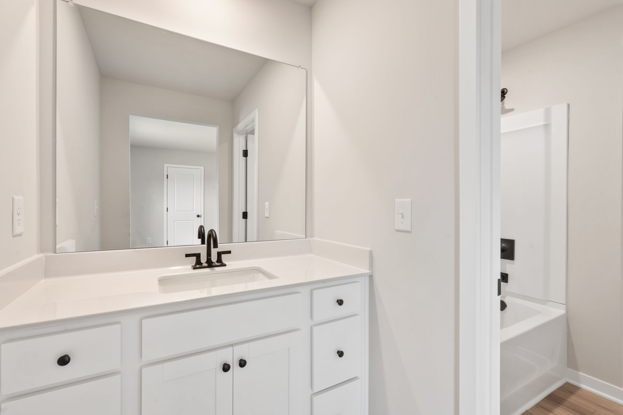 A bathroom with a sink and a mirror.