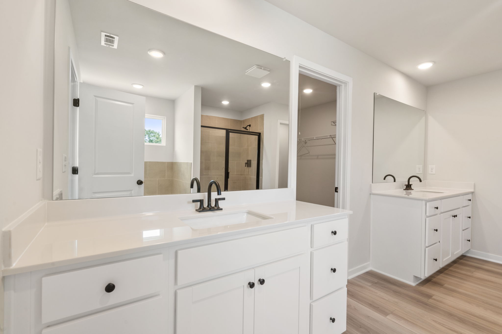 A bathroom with white cabinets.