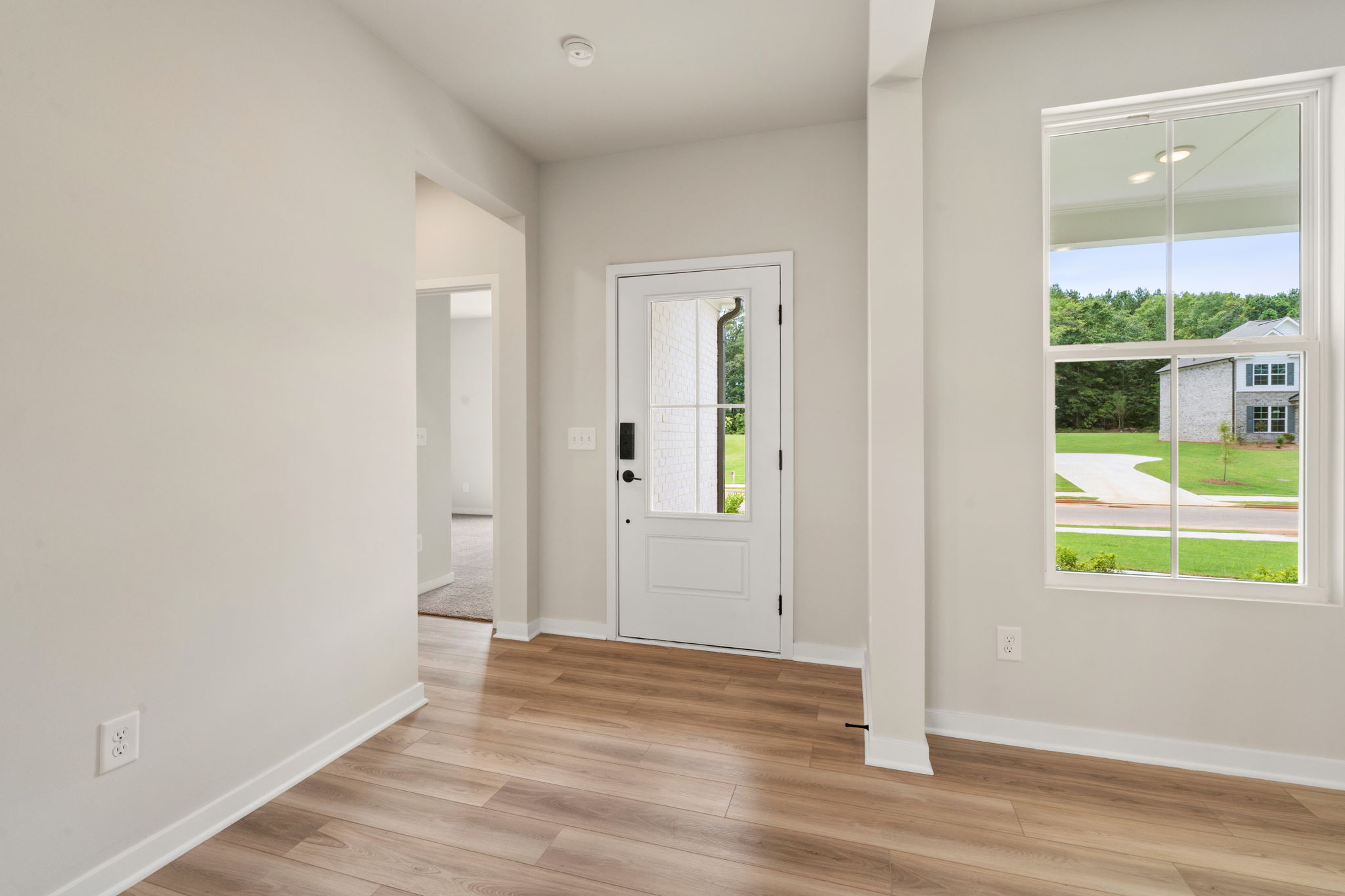 A room with white walls and a wood floor.
