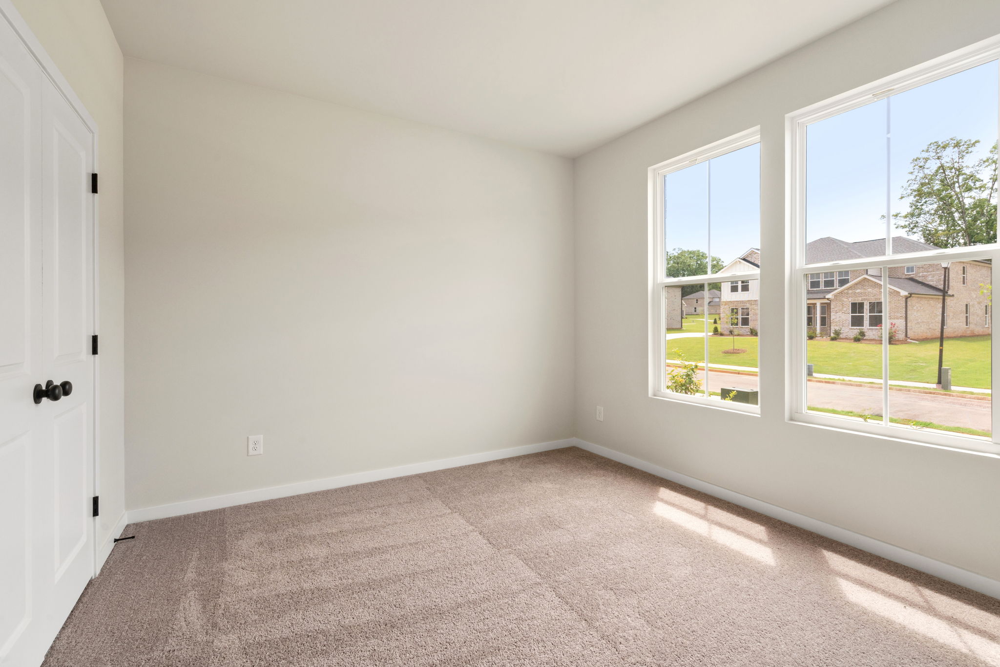 A room with windows and a door.