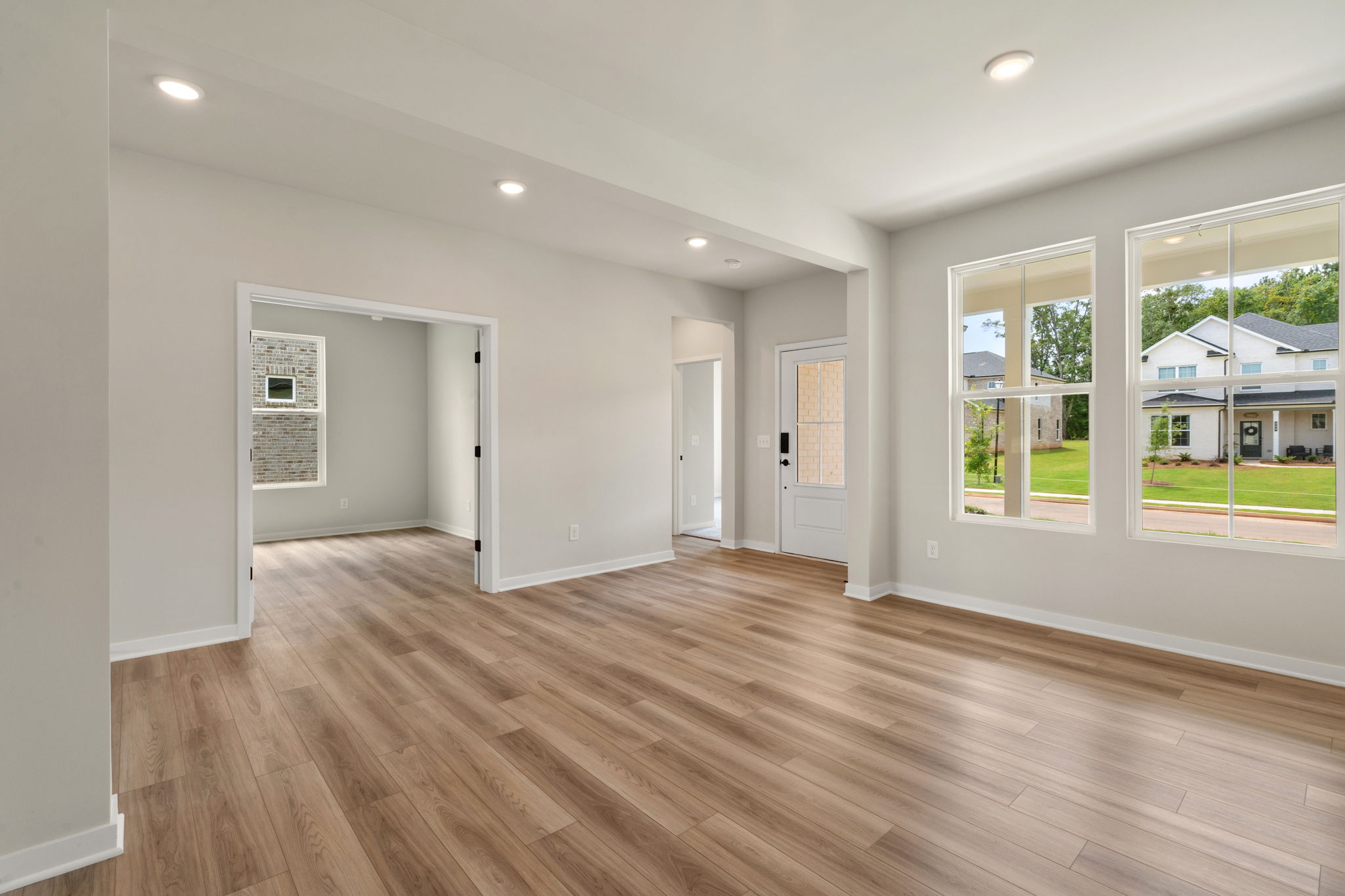 A room with a wood floor and windows.