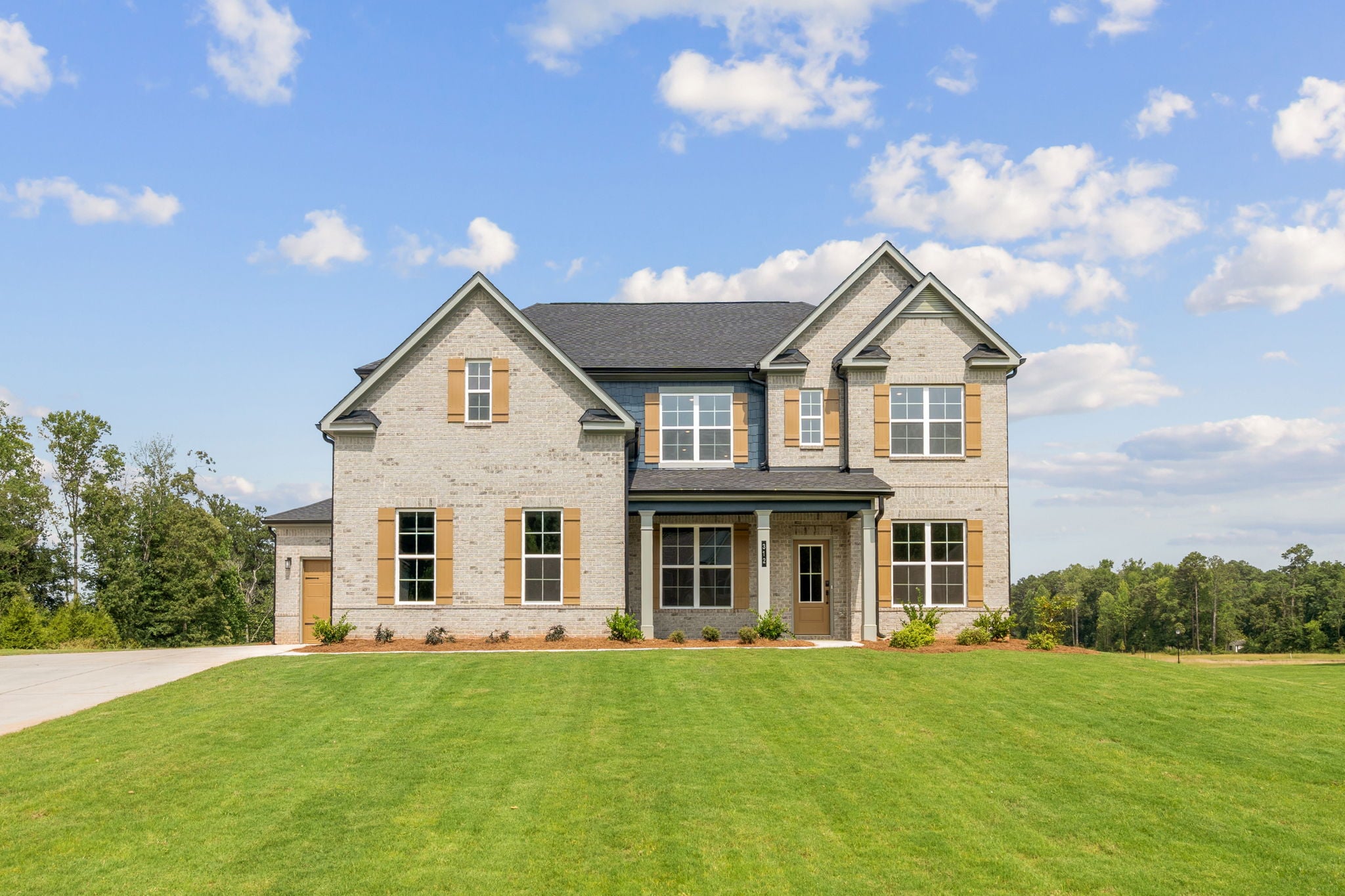 A large house with a lawn in front of it.