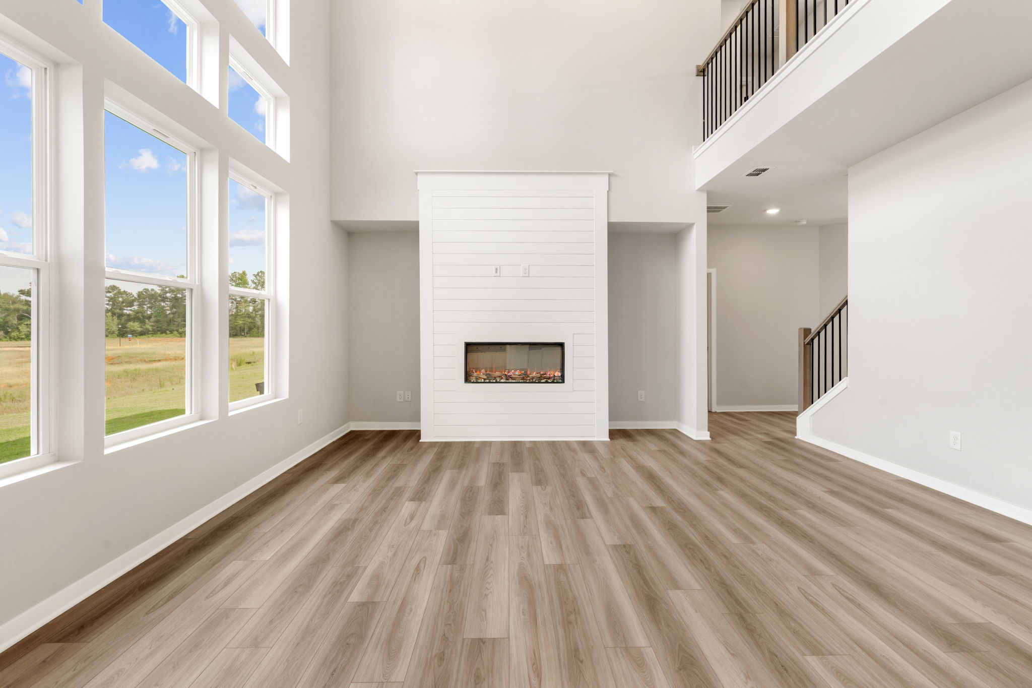 A room with a fireplace and a wood floor.